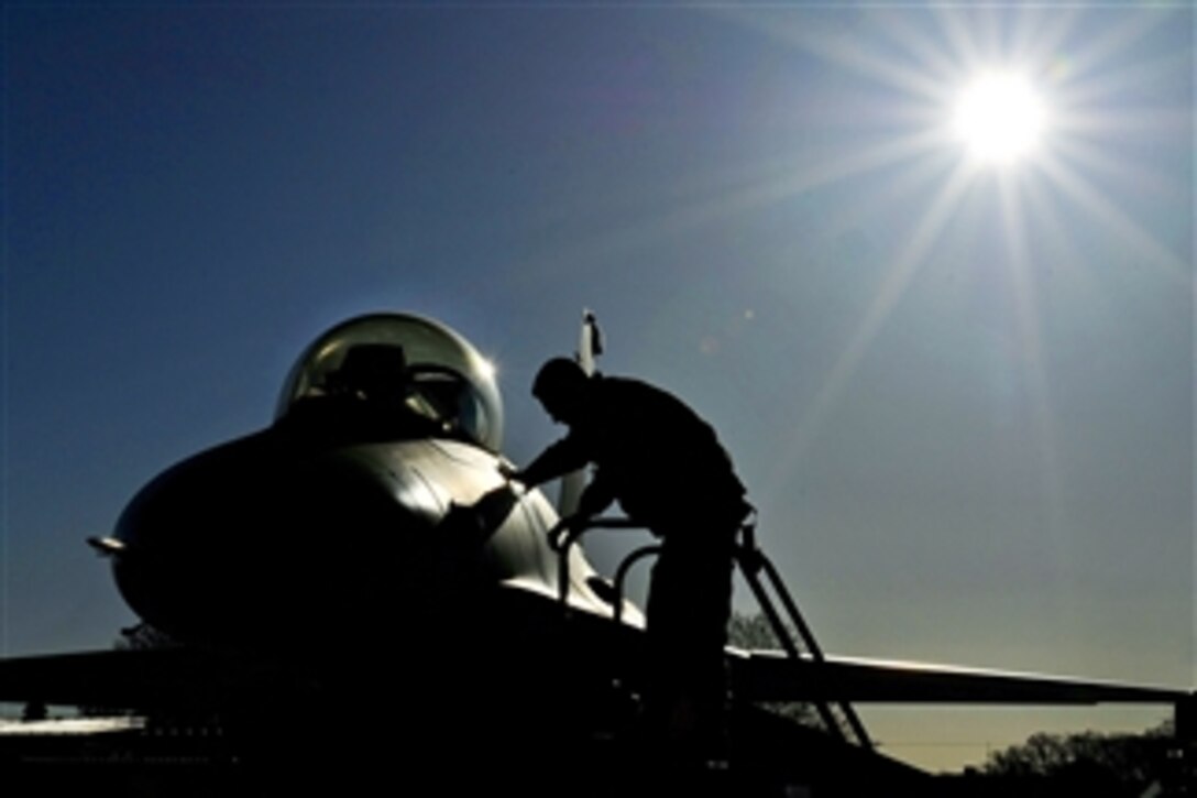 An airman prepares an F-16 Fighting Falcon for flight at Joint Base Andrews, Md., on April 3, 2012.  The 113th Wing provides air sovereignty forces to defend the nation's capital and support forces ranging from local to global employment. The airman is assigned to the 113th Aircraft Maintenance Squadron.  