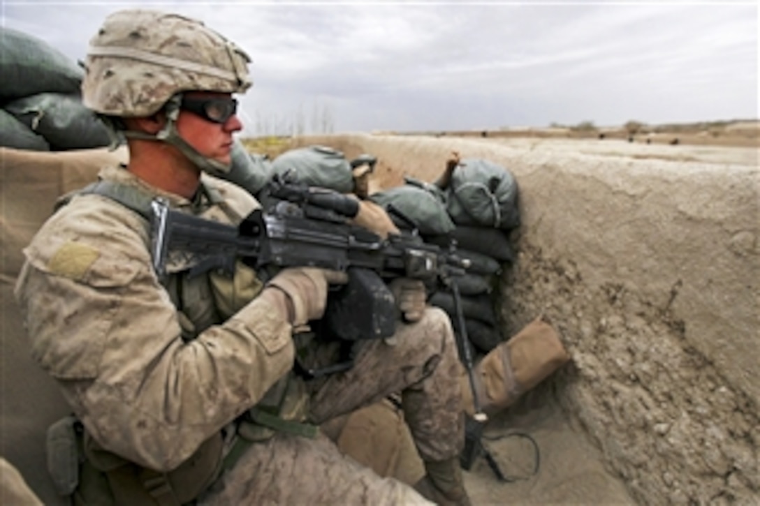 U.S. Marine Corps Cpl. Daniel Thompson provides security while members of an Afghan narcotics interdiction unit search a compound during Operation Speargun in Urmuz, Afghanistan, on March 27, 2012.  Thompson is a fire team leader assigned to Alpha Company, 1st Combat Engineer Battalion, 8th Marine Regiment.  