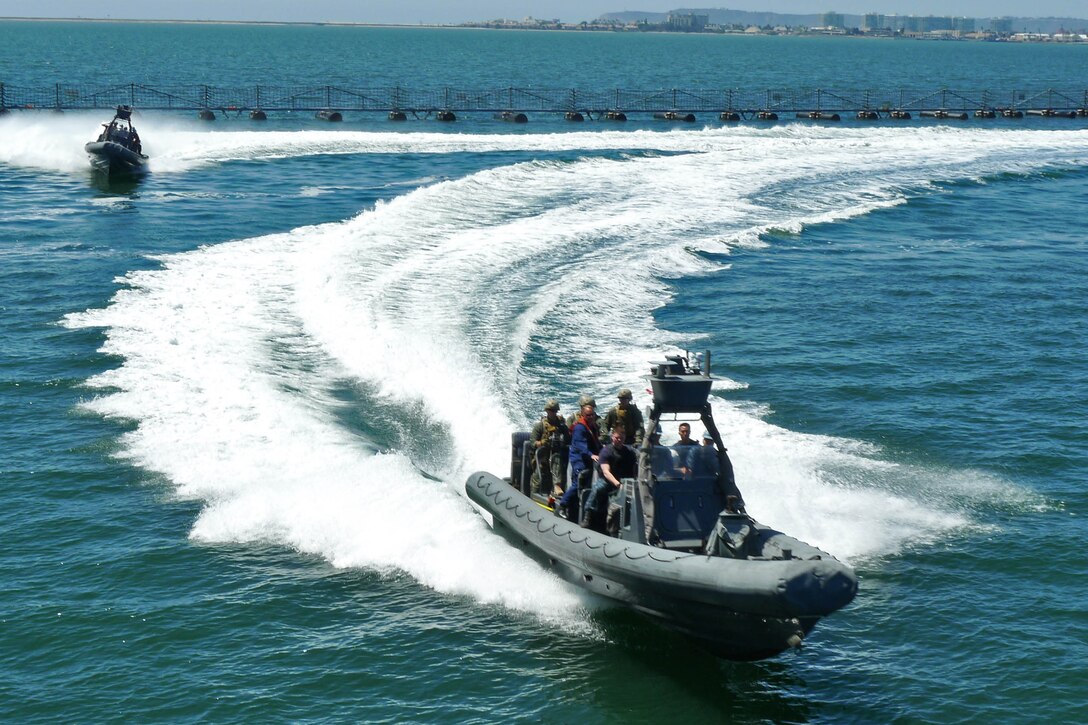 Marines from the 15th Marine Expeditionary Unit’s Maritime Raid Force prepare to board the USS Dewey from rigid-hulled inflatable boats during a visit, board, search and seizure exercise, April 9 at Naval Base San Diego. The MRF's primary role is to carry out raids against maritime objectives including gas and oil platforms, ships and targets on shore. This was the first time the MRF was able to practice their unique skill sets as a cohesive unit. (U.S. Marine Corps photo by Lance Cpl. Timothy Childers)