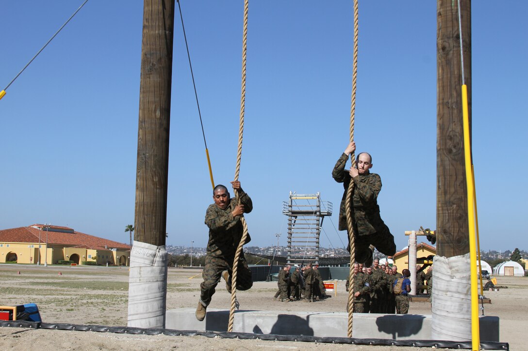 Company I recruits run and jump on ropes to swing between platforms at the confidence course aboard Marine Corps Recruit Depot San Diego April 9.