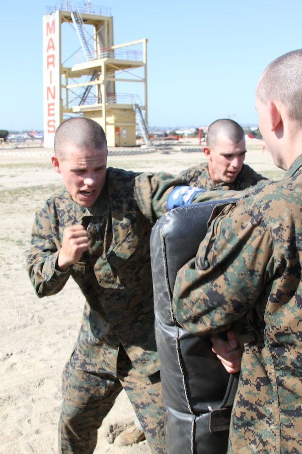 Recruit Ian Sewalt, guide, Platoon 3210, Co. I, 3rd Recruit Training Battalion, works on his lead hand punch with a partner between obstacles at the confidence course aboard Marine Corps Recruit Depot San Diego April 9. The additional exercises allow recruits to see how far they can push themselves when tired.