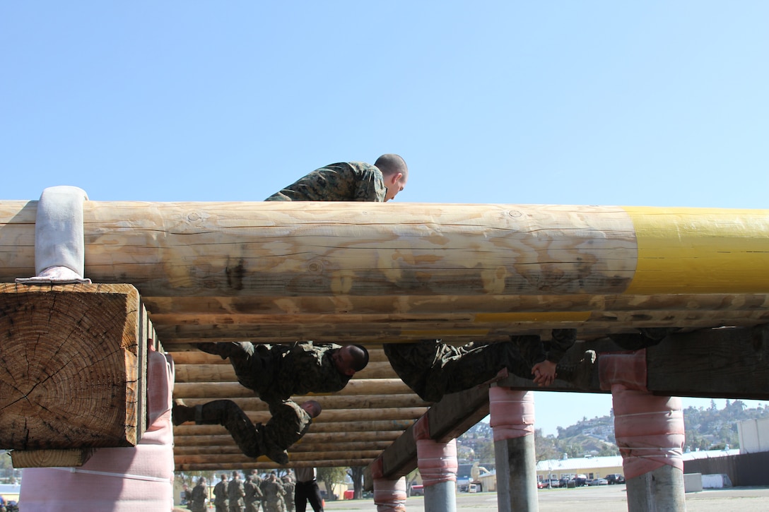 Without touching the ground recruits must alternate over and under each log to complete this obstacle at the confidence course aboard Marine Corps Recruit Depot San Diego April 9. Although the course focuses on upper body strength, recruits run in place before each obstacle and run to their next obstacle.::r::::n::
