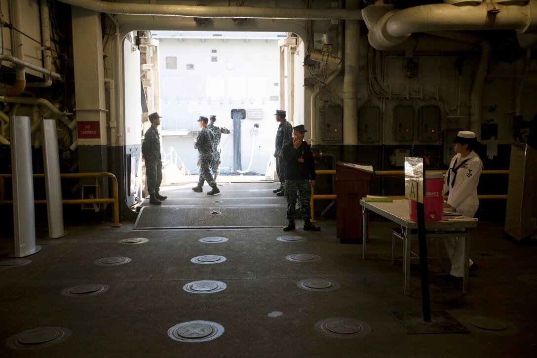 Sailors greet Marines of the 26th Marine Expeditionary Unit as they board the USS Wasp at Norfolk Naval Station, Va., April 9, 2012.The 26th Marine Expeditionary Unit is currently providing support to the Commemoration of the Battle of New Orleans. Starting this April and continuing through 2015, the U.S. Navy, U.S. Marine Corps and U.S. Coast Guard will commemorate the Bicentennial of the War of 1812 and the Star Spangled Banner.  The War of 1812 celebration will commemorate the rich Naval history and showcase the capabilities of today's Navy-Marine Corps team.