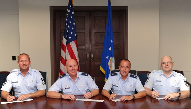 15th Wing and 647th Air Base Group leadership donate to the Air Force Assistance Fund during the annual six-week AFAF campaign at Joint Base Pearl Harbor Hickam, HI, April 10. The Air Force has an overall goal of raising $6.4 million. (U.S. Air Force photo/Senior Airman Lauren Main)