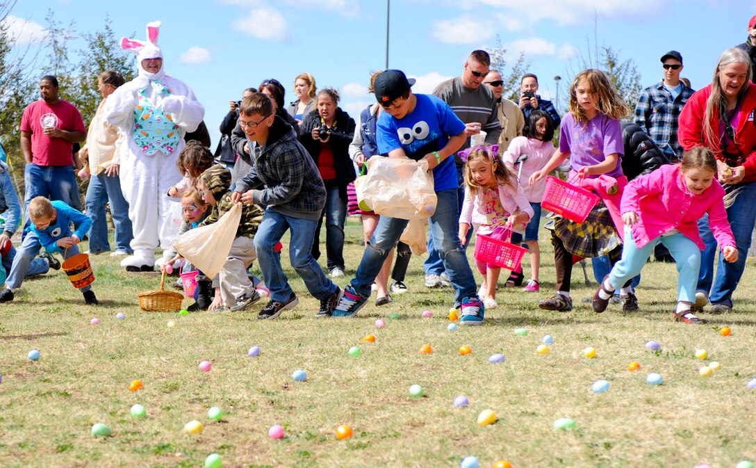 Children race to gather plastic eggs during the Easter egg hunt at the Exchange on Ellsworth Air Force Base, S.D., April 7, 2012. The plastic eggs included a wide range of candy and prizes donated by base exchange vendors.  (U.S. Air Force photo by Airman 1st Class Anania Tekurio/Released)