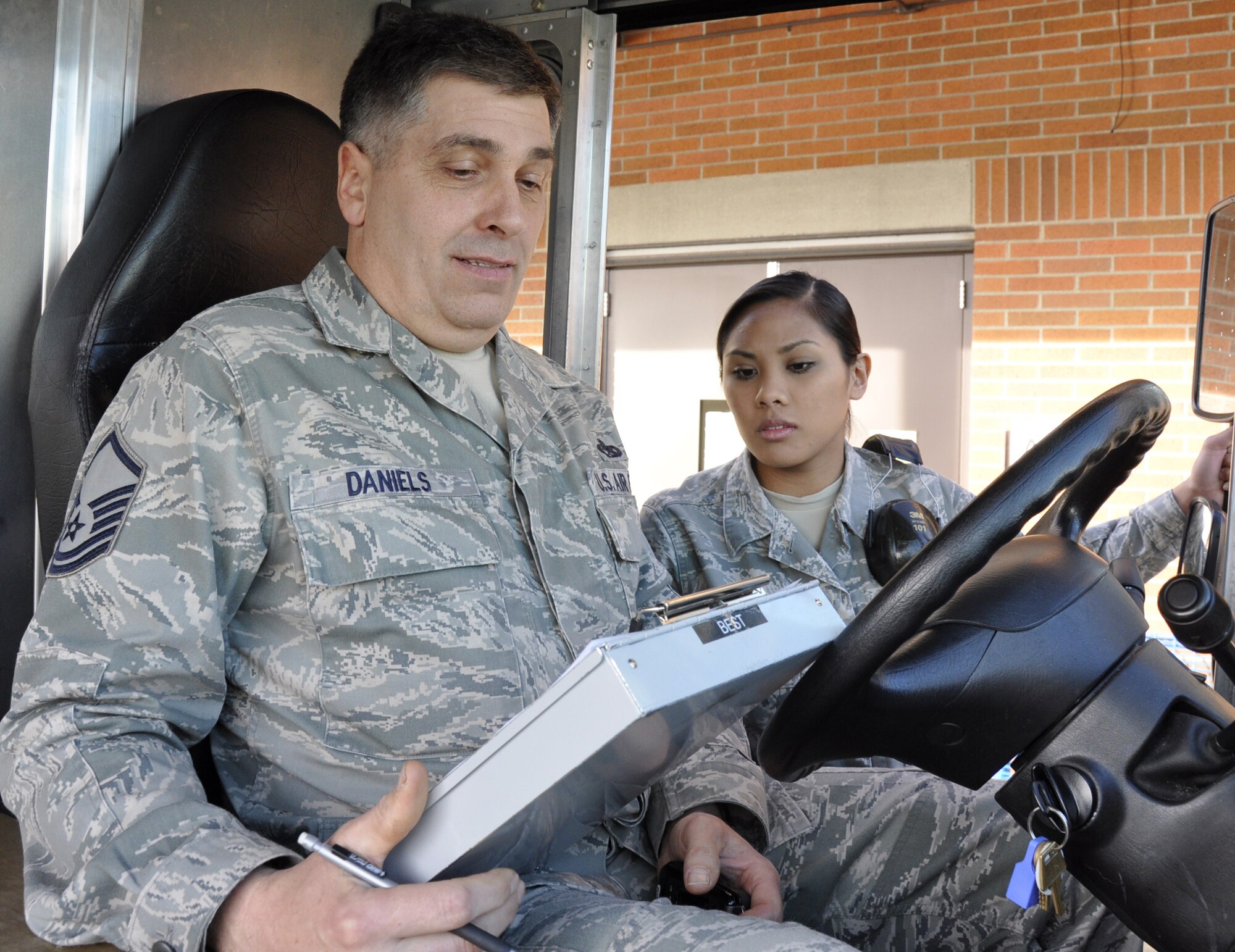 Master Sgt. Jeffrey Daniels and Senior Airman Mailani Akey, both with the 446th Aircraft Maintenance Squadron, McChord Field, Wash., go over flightline expeditor logs during the Reserve weekend, April 1, 2012. Both maintainers won the Air Mobility Command Outstanding Reserve Associate Maintenance Award for 2012. Daniels earned his award in the supervisor category and Akey won hers as a technician. (U.S. Air Force photo/Master Sgt. Jake Chappelle)