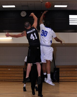 Caleb “Squatch” Parton and DeShawn Howard jump for the tipoff during the opening of the Battle of the Sexes basketball game on Davis-Monthan Air Force Base, Ariz. April 6, 2012. Howard and Jonathan Ayers, both assistant coaches for the D-M women’s varsity team, joined the women’s team against the 2011 Intramural Basketball Champions the 355th Equipment Maintenance Squadron. (U.S. Air Force photo by Airman 1st Class Timothy D. Moore/Released)