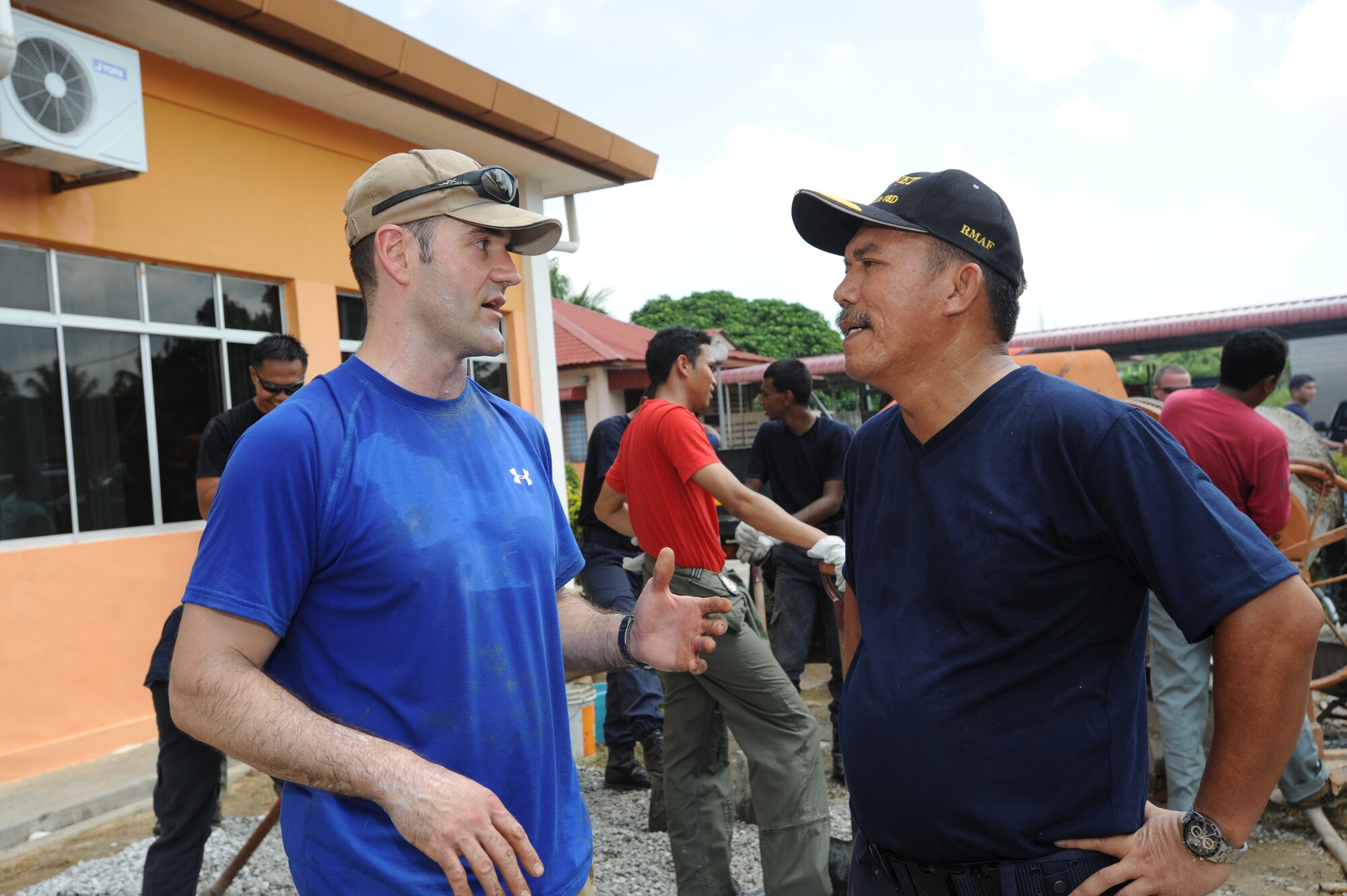Lt. Col. Andy Shobe (left), 67th Fighter Squadron detachment commander at Kadena Air Base, Japan, talks with Royal Malaysian Air Force Brig. Gen. Shabre Bin HJ Hussein, TUDM Butterworth commander, during a break in construction at the Pembangunan Anak-Anak Yatim Bekas Perajurit Malaysian orphanage in Kulim, Malaysia, on April 8, 2012.  More than 50 U.S. Air Force and RMAF members spent the day mixing and pouring concrete to create a multi-use sports court at the orphanage as part of a humanitarian construction project held during Cope Taufan 2012. Exercise Cope Taufan 12 is a Pacific Air Forces sponsored exercise involving dissimilar basic fighter maneuver and dissimilar air combat tactics training with the U.S. and Royal Malaysian Air Forces at Tudm Butterworth, Malaysia, 4-13 Apr 12.(U.S. Air Force photo/Master Sgt. Matt Summers)