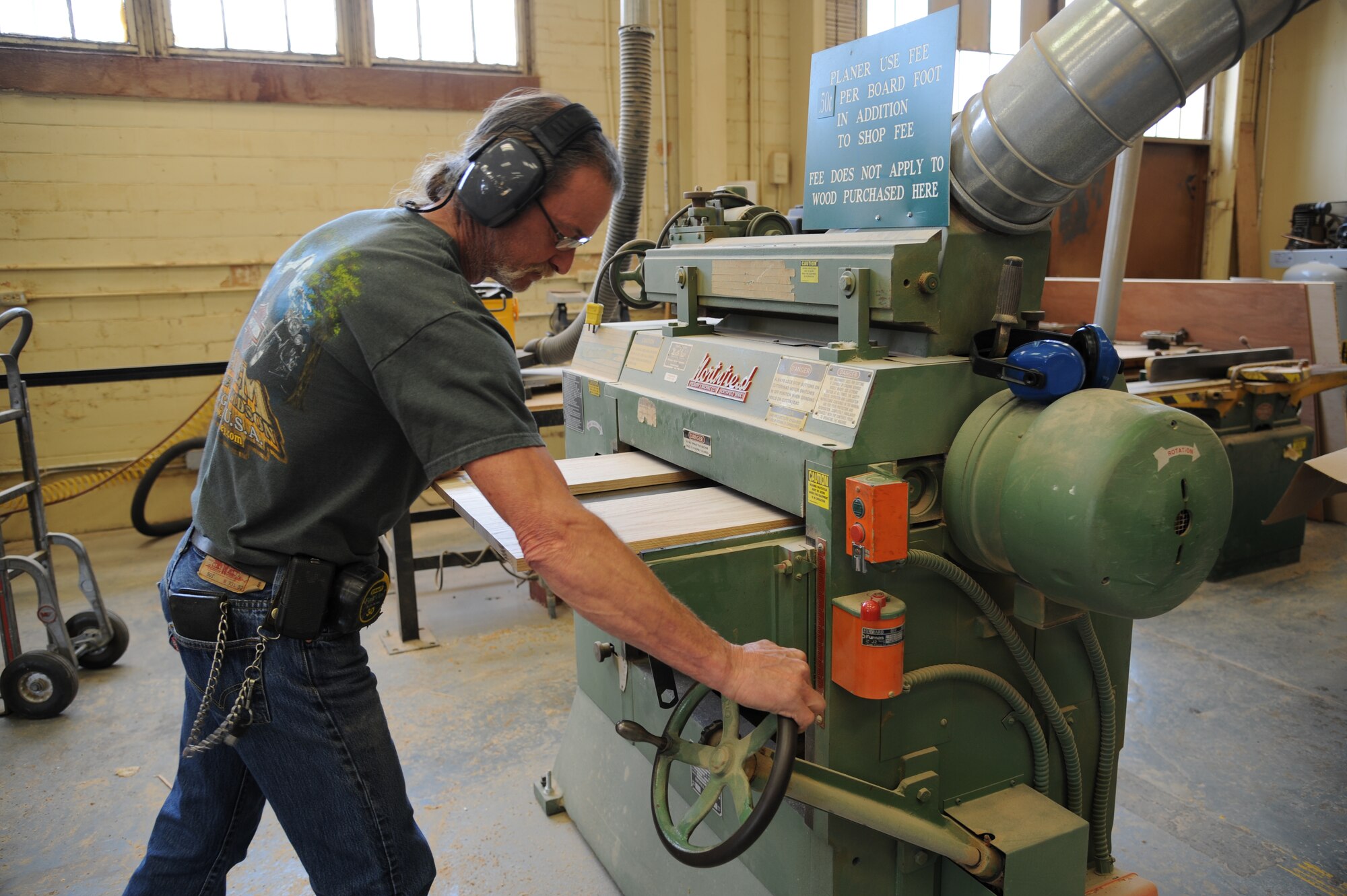 Mike Jarrett, 2nd Force Support Squadron Wood Craft Center manager, uses a drum sander in the Arts and Crafts Center on Barksdale Air Force Base La., April 10. The facility and equipment can be used for a small hourly fee by those who are certified. Certification classes begin on the second Tuesday of every month, and are held on Tuesdays and Thursdays. During the four day course, students are taught how to safely use the facility's equipment while completing a finished project. (U.S. Air Force photo/Airman 1st Class Andrew Moua)(RELEASED)
