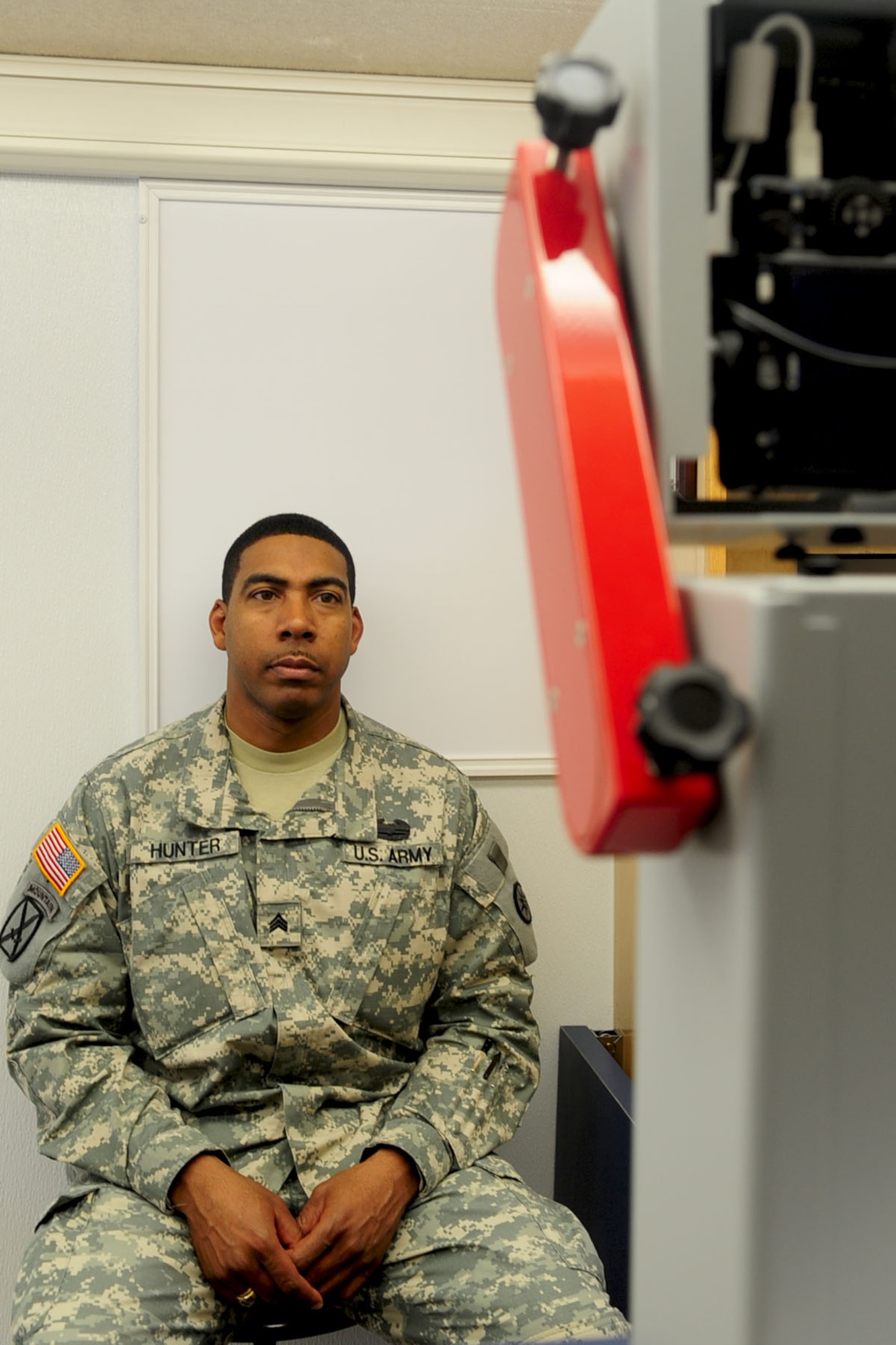 U.S. Army Sgt. Hilton Hunter, a Soldier assigned to the Fort Eustis Warrior Transition Unit, poses for a driver's license photo inside the DMV 2 Go mobile unit at Fort Eustis, Va., April 10, 2012. DMV 2 Go visits businesses, university and college campuses, assisted living facilities and retirement communities, military bases and government centers across the state of Virginia to bring DMV services conveniently to customers. (U.S. Air Force photo by Staff Sgt. Ashley Hawkins/Released)