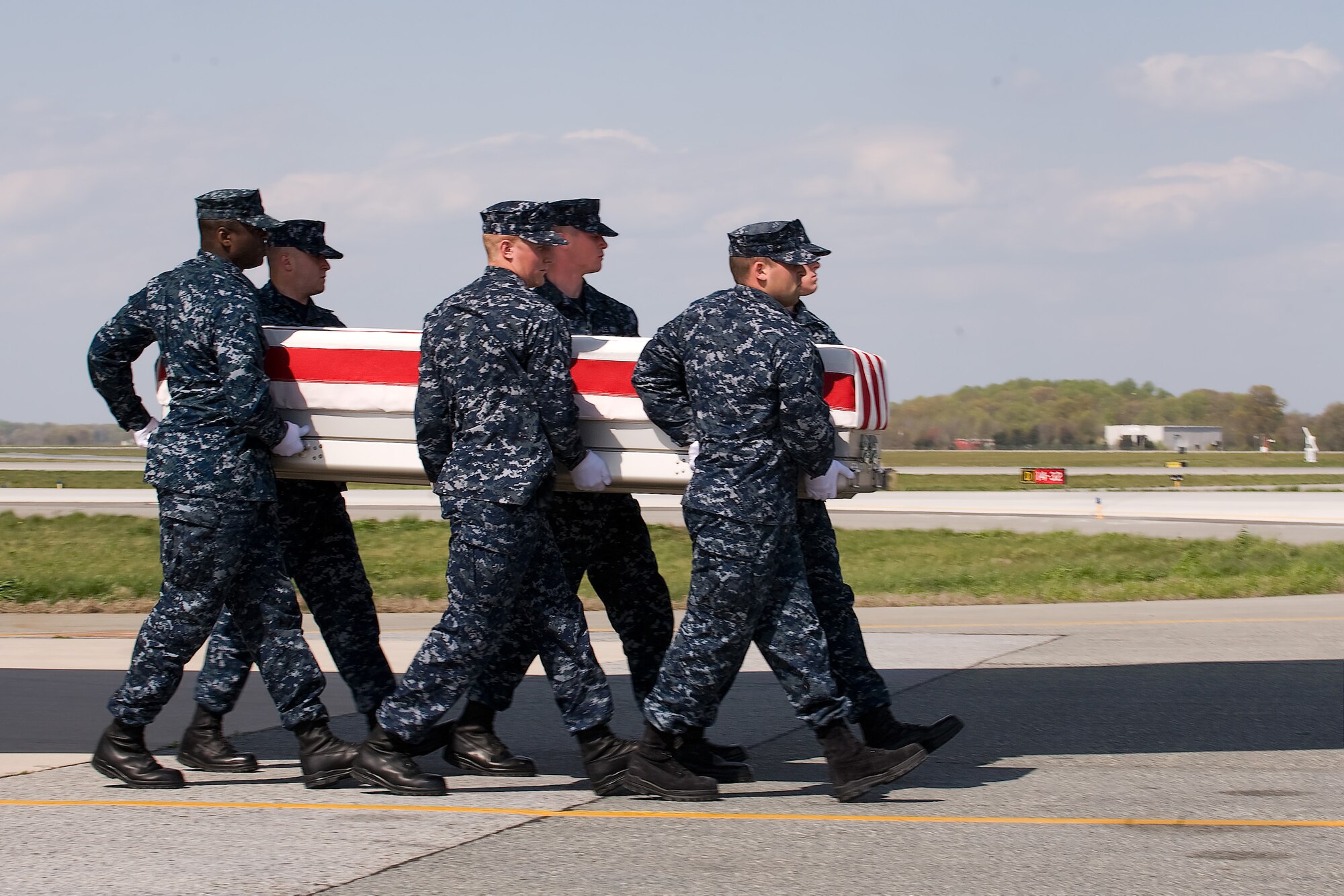 A U.S. Navy carry team transfers the remains of Constructionman Trevor J. Stanley, of Virginia Beach, Va., at Dover Air Force Base, Del., April 10, 2012. Stanley was assigned to Naval Mobile Construction Battalion 3, Port Hueneme, Calif. (U.S. Air Force photo/Steve Kotecki)