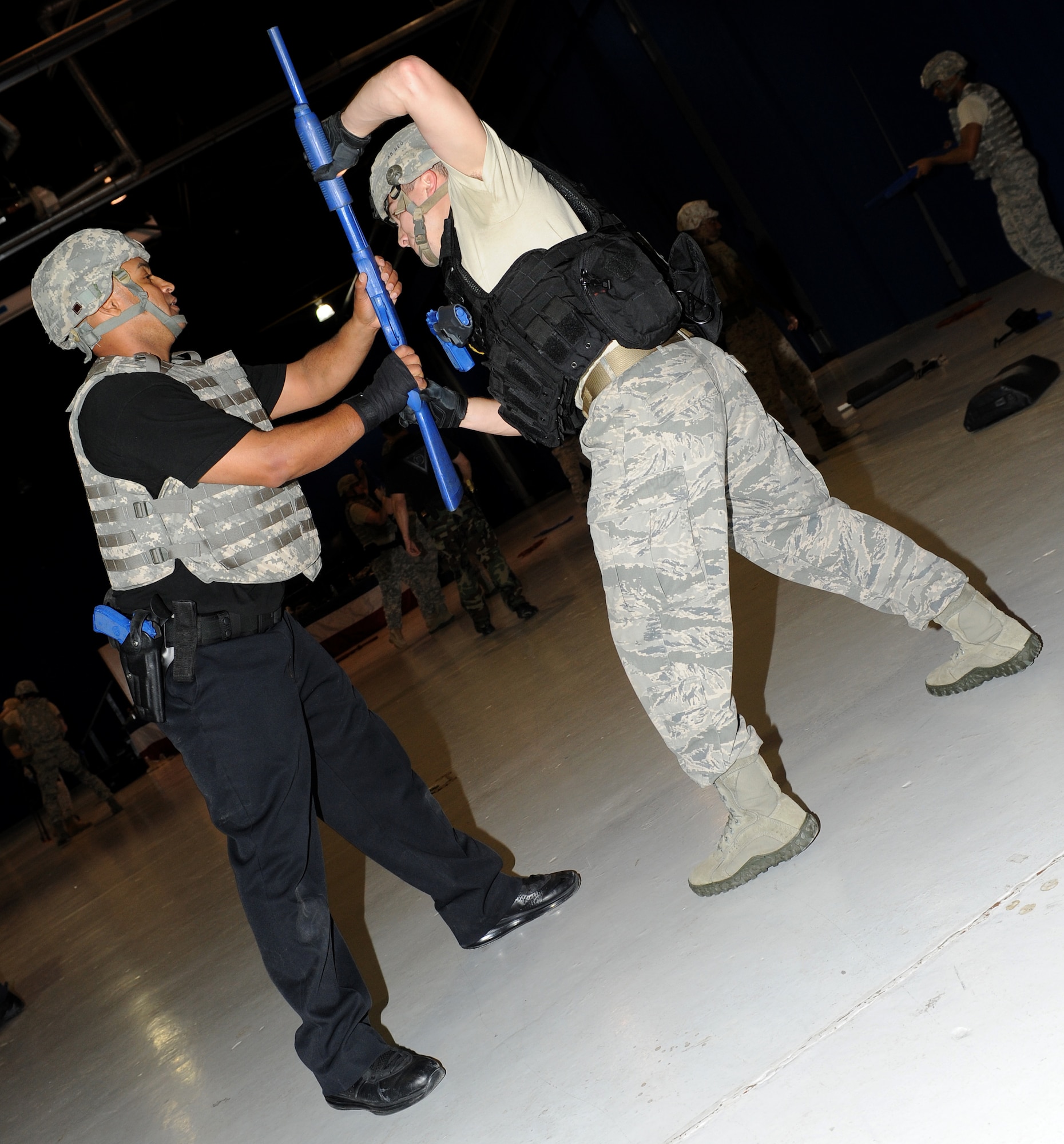 U.S. Air Force Senior Airman Corie Flores, right, 633rd Security Forces Squadron patrolman, practices taking a weapon away from Marvin Smith, left, Department of the Air Force police officer, during a 7-day Krav Maga course at Langley Air Force Base, Va., April 7, 2012. Students learn to defend themselves against a variety of potential attacks. (U.S. Air Force photo by Airman 1st Class Teresa Cleveland/Released)