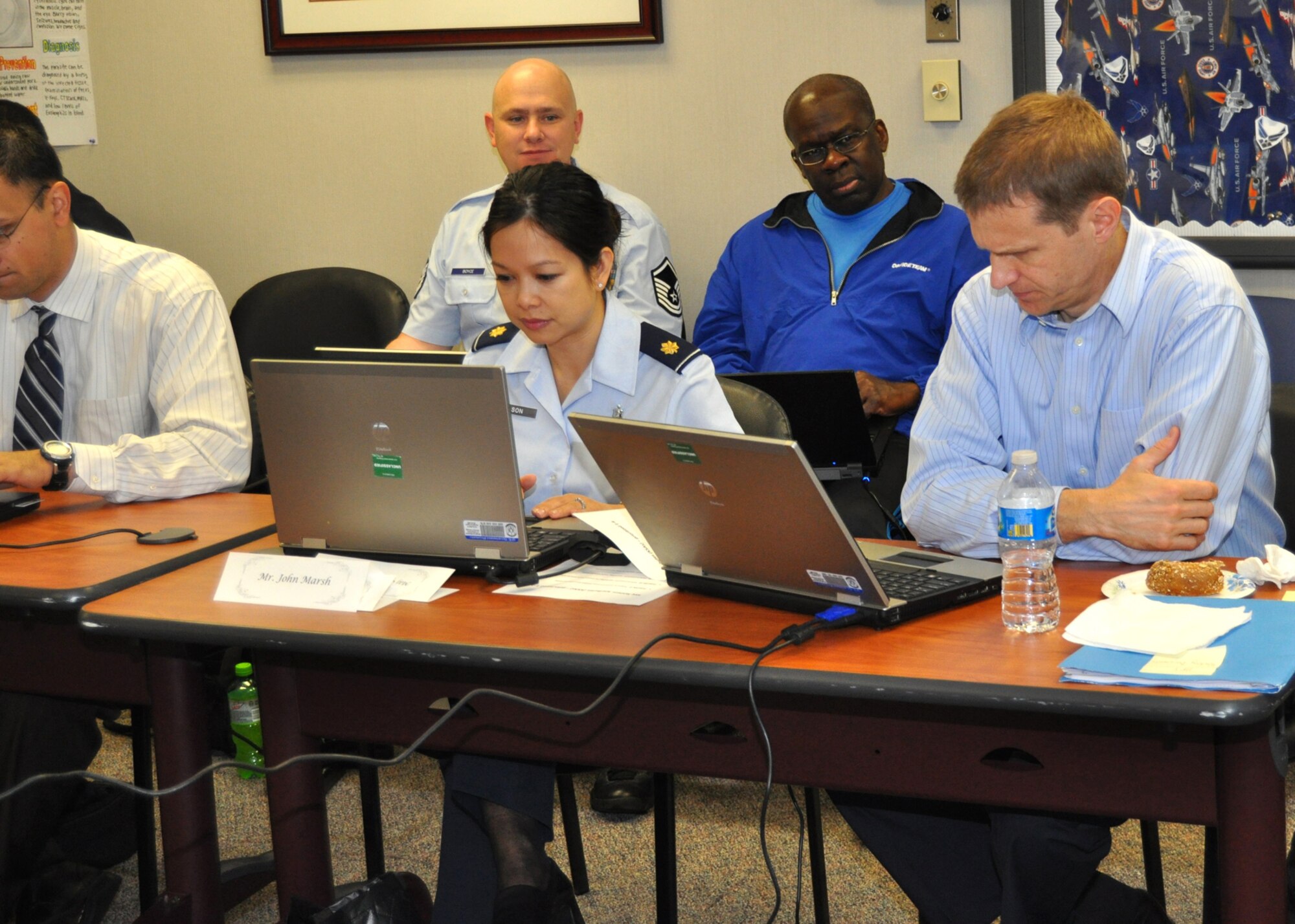 Maj. Mona Dionisionelson and John Marsh, Air Force Medical Support Agency Acquisitions Requirements Development, foreground, act as facilitators for a meeting March 21, 2012, at the 81st Medical Group, Keesler Air Force Base, Miss., as telehealth subject matter experts  Master Sgt. Larry Boyce, AFMSA Medical Information, and  Russell Henderson AFMSA Telehealth, look on. The meeting was to discuss and develop the requirements for a telepathology capability at Air Force Medical Centers.  (U.S. Air Force photo by Steve Pivnick)