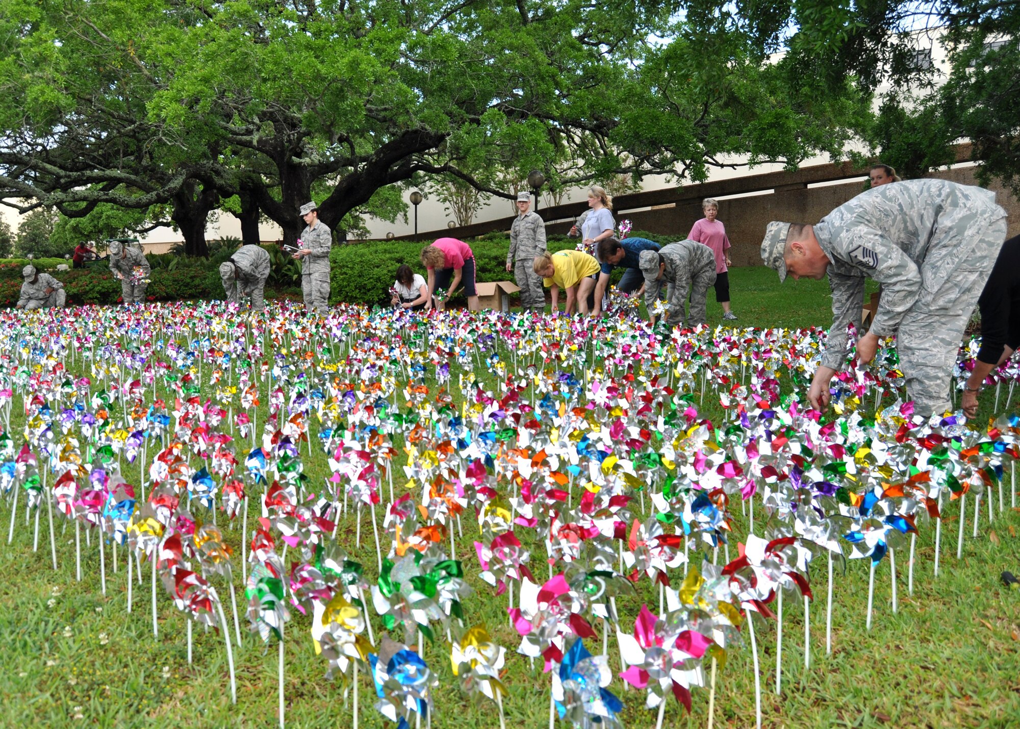 Volunteers place 1,000 pinwheels in front of the 81st Medical Group April 3, 2012, at Keesler Air Force Base, Miss., as they have been every year since 2007. “Pinwheels for Prevention” is an annual program that uses the shining, colorful display to raise awareness of the more than 1,000 allegations of child abuse in Harrison and Jackson counties alone.  (U.S. Air Force photo by Steve Pivnick)