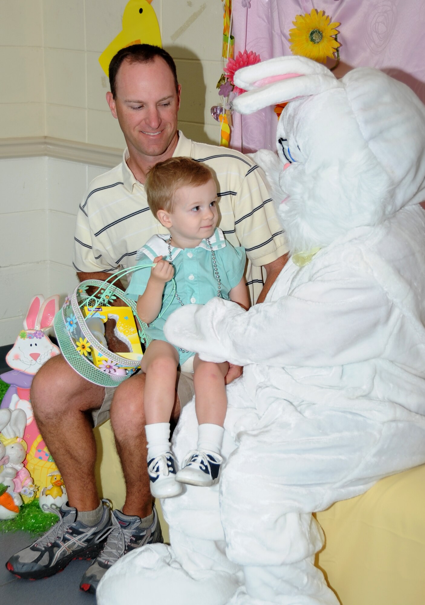 Maj. (Dr.) Stephen Gasparovich, 81st Dental Squadron, and his 2-year-old son, Carter, take a photo with the Easter Bunny following the Easter egg hunt and parade hosted by Keesler’s Outdoor Recreation Center in the marina park, April 7, 2012 at Keesler Air Force Base, Miss.  (U.S. Air Force photo by Kemberly Groue)