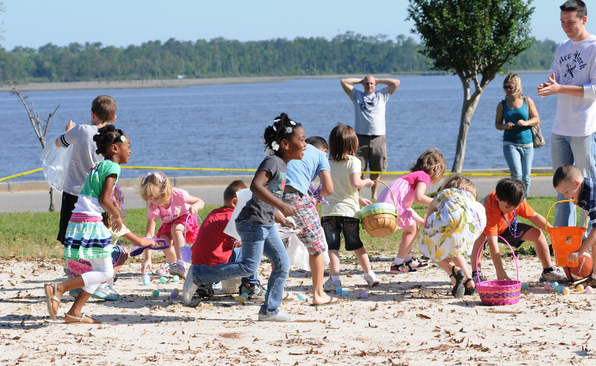 Children search for plastic eggs at the Easter egg hunt and parade in marina park, April 7, 2012 at Keesler Air Force Base, Miss.  The base’s outdoor recreation center hosted the event beginning with a parade and the arrival of the Easter Bunny followed by an egg hunt with more than 5,000 candy filled eggs hidden throughout the park.  Children searched for eggs in three separate age divisions.  There were 30 prize eggs which awarded chocolate bunnies and one grand prize egg in each division that included a tricycle for the youngest age group and bicycles for the two older age groups. (U.S. Air Force photo by Kemberly Groue)