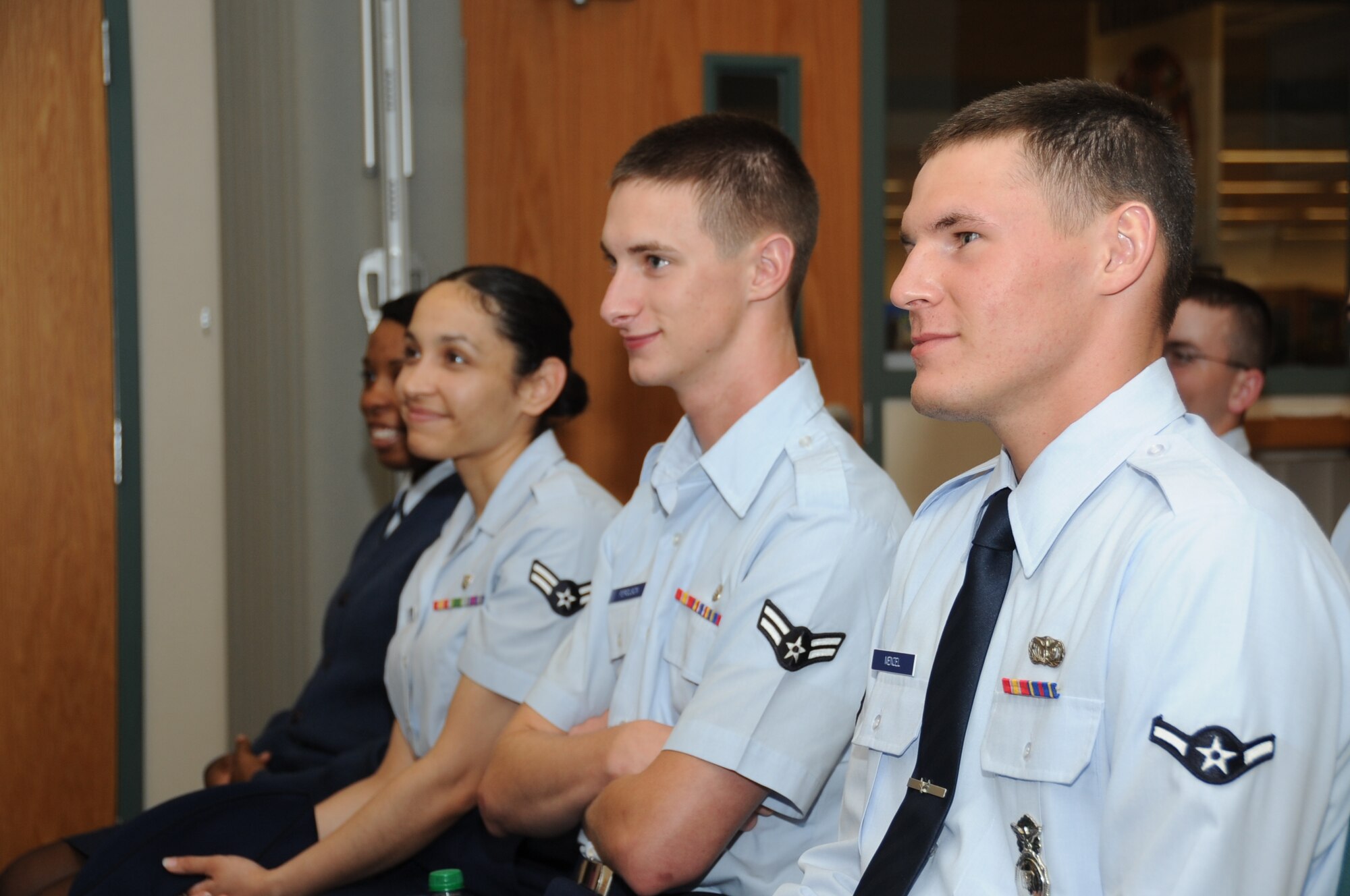 Airman First Class Shamara Robertson, 81st Diagnostic and Therapeutics Squadron; Airmen First Class Erika Vega and Robert Ferguson, 81st Inpatient Operation Squadron; and Airman Paul Menzel, 81st Security Forces Squadron, listen to Retired Col. Mike Cavanaugh, who currently lives in Thailand, share memories from his time during the Vietnam War as a Raven and also of Maj. Edward “Hoss” McBride, whom the library is named after.  Ravens were the classified and prestigious pilots who accomplished missions all over Southeast Asia in the Vietnam era.  (U.S. Air Force photo by Kemberly Groue)