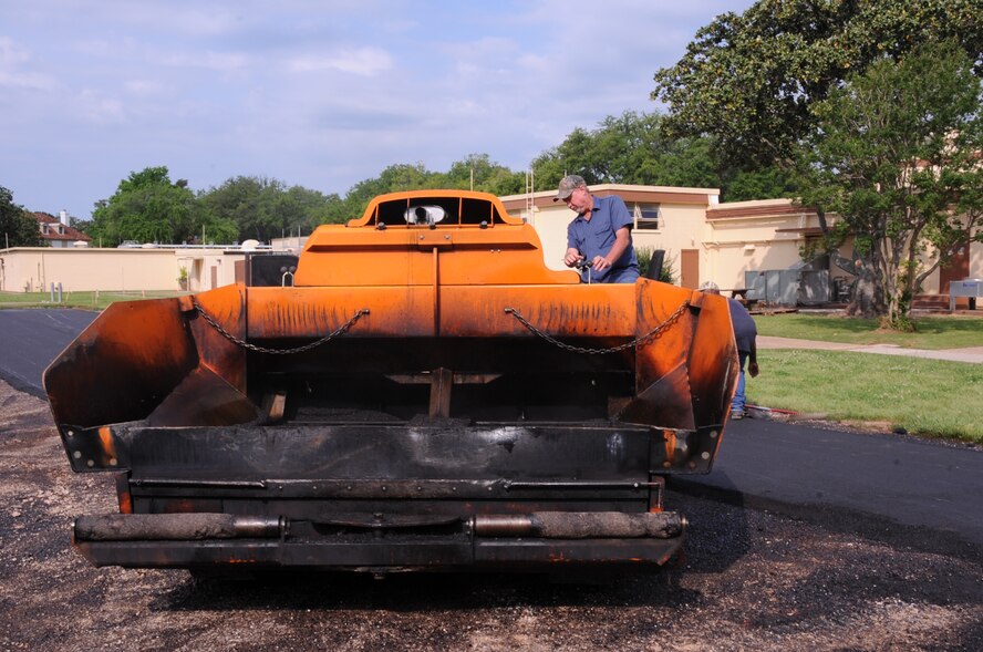 Tommy Fussell, contractor, prepares to lay down asphalt for the new Air Force Global Strike Command parking lot on Barksdale Air Force Base, La., April 9. The new parking spaces will more than double the amount of space for AFGSC members to utilize.(U.S. Air Force photo/Airman 1st Class Andrew Moua)(RELEASED)