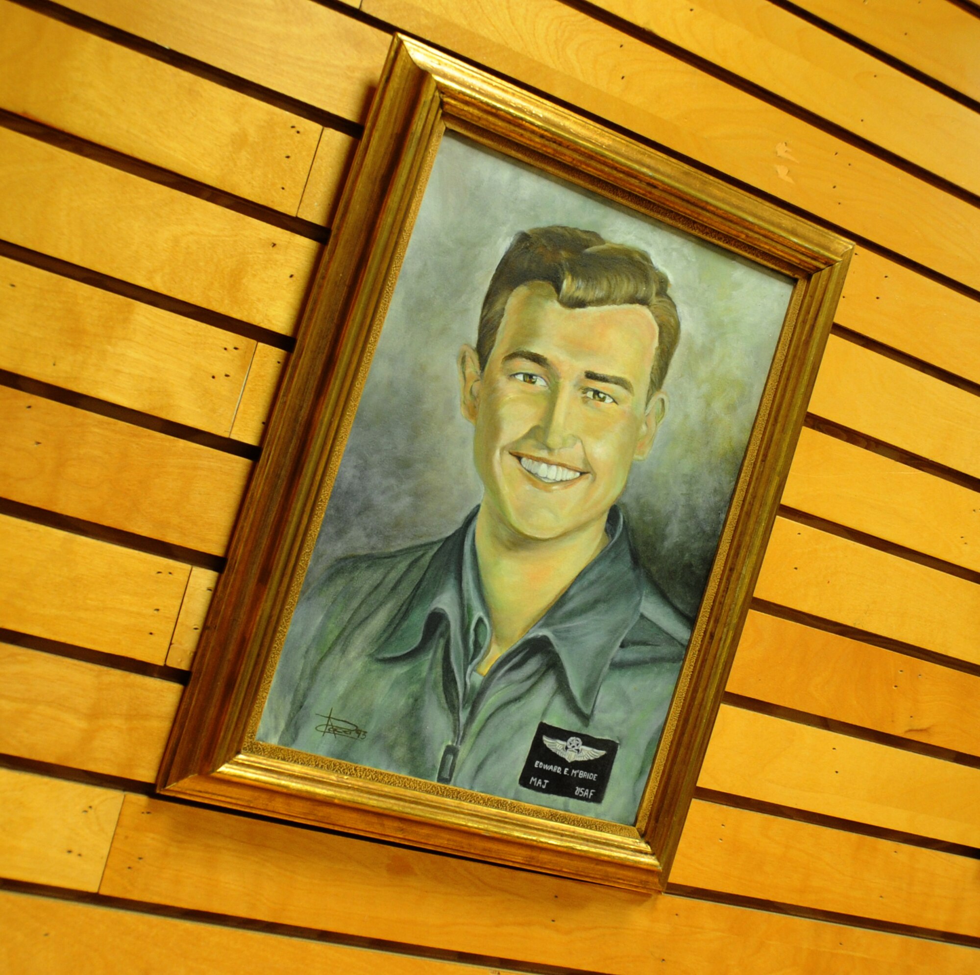 A painted portrait of Maj. Edward “Hoss” McBride hangs on display inside the McBride Library whom the library is named after, at Keesler Air Force Base, Miss.  A fellow Raven of McBride, retired Col. Mike Cavanaugh, shared his memories of McBride and as a Raven, April 9, 2012.  (U.S. Air Force photo b Kemberly Groue)