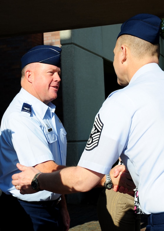 Col. Erik Hansen greets Chief Master Sergeant of the Air Force James Roy upon his arrival at Joint Base Charleston - Air Base April 9. Hansen is the 437th Airlift Wing commander. (U.S. Air Force photo/Staff Sgt. Katie Gieratz) 