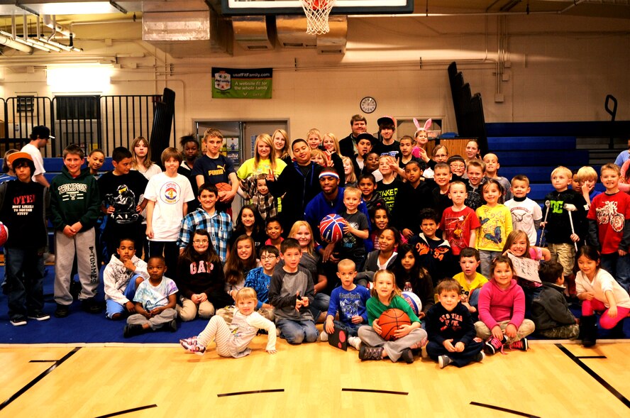 Harlem Globetrotter Hammer Harrison poses for a group photo at the Youth Center on Grand Forks Air Force Base, N.D., on April 9, 2012. He came to GFAFB to motivate and educate children with the program “C.H.E.E.R. For Character” designed by the Globetrotters. This program helps children become better prepared for challenges they will face as young adults. (U.S. Air Force photo by Staff Sgt. Amanda Grabiec)