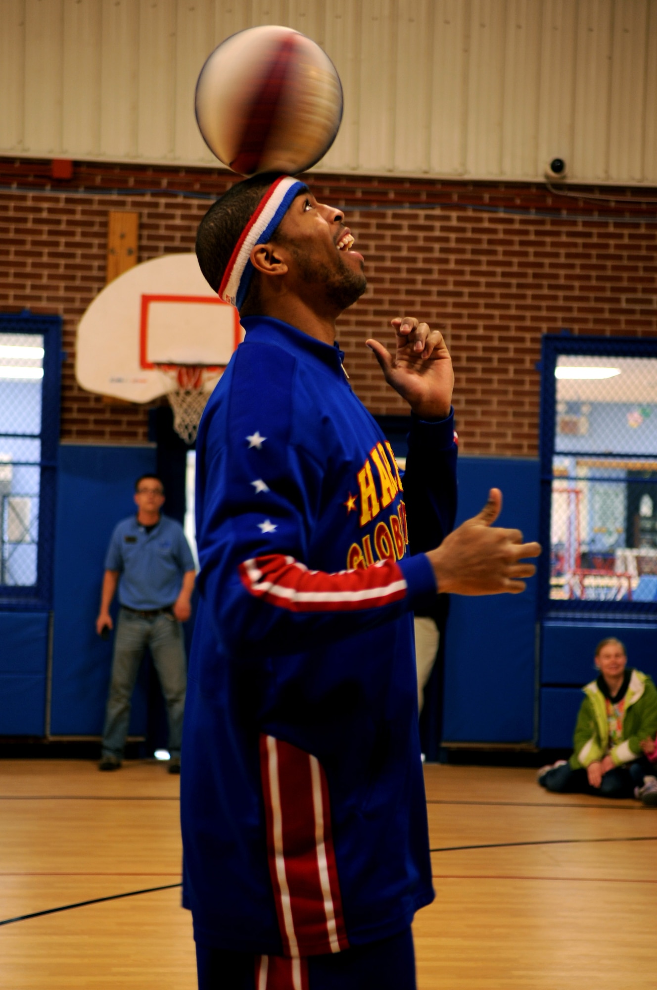 Harlem Globetrotter Hammer Harrison performs at the Youth Center on Grand Forks Air Force Base, N.D., on April 9, 2012. Harrison came to GFAFB to motivate and educate children with the program “C.H.E.E.R. For Character” designed by the Globetrotters. This program helps children become better prepared for challenges they will face as young adults. (U.S. Air Force photo by Staff Sgt. Amanda Grabiec)