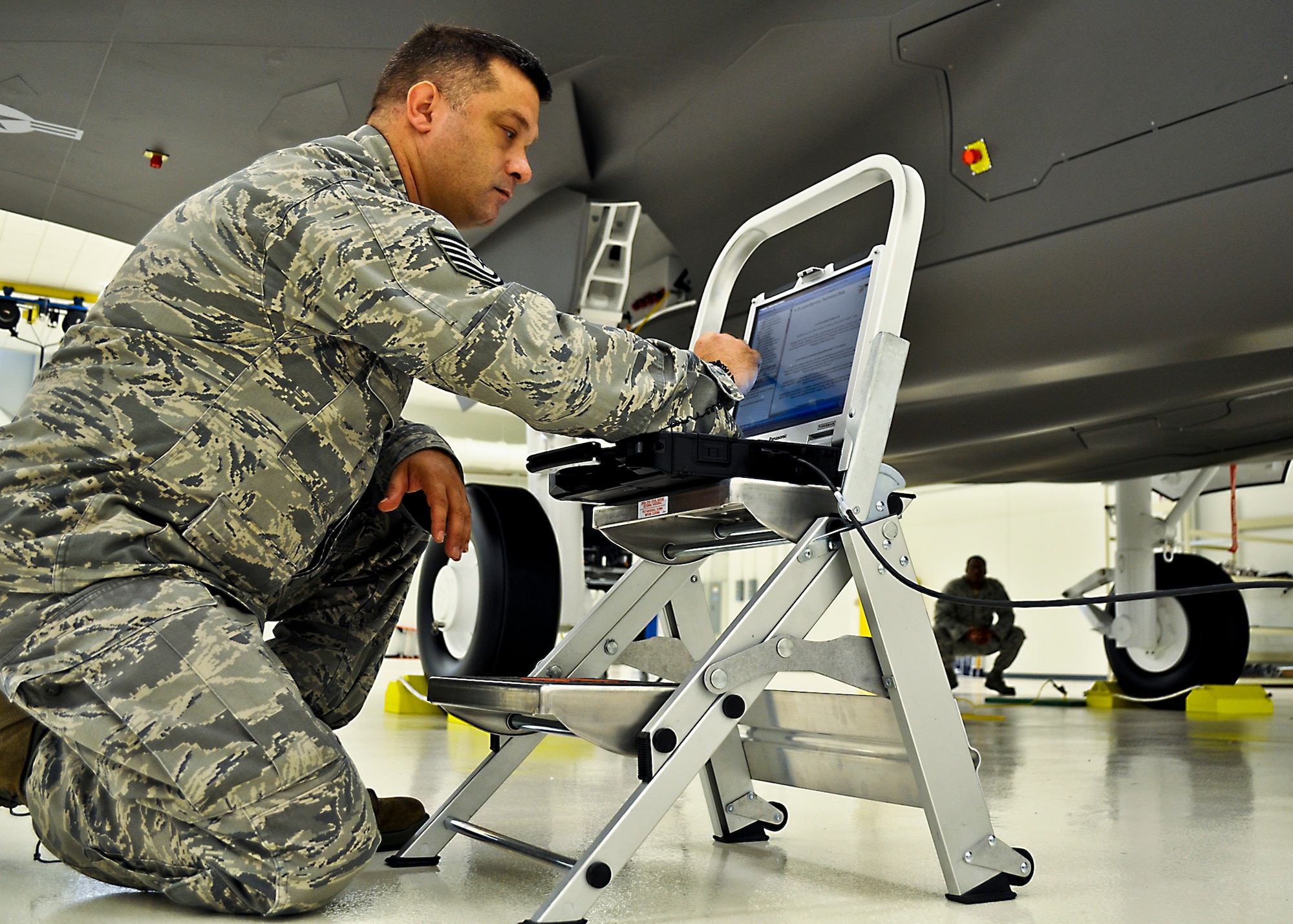 Tech. Sgt. Brandon Sullivan, an aircraft armament systems technician with the 33rd Aircraft Maintenance Squadron, is using a portable maintenance device loaded with joint technical data and plugged into an F-35 life-sized trainer during a weapons familiarization course. Training indoors allows for deliberate training for the maintainers without having to take a real jet off the flight line thus competing with pilot training. Later training on the flight line is streamlined due to the preparation on the mock-ups. The 17-day weapons familiarization class was the first-ever weapons course completed since Eglin’s F-35 Academic Training Center began commencement of formal training Mar 19. (U.S. Air Force photo/Maj. Karen Roganov)