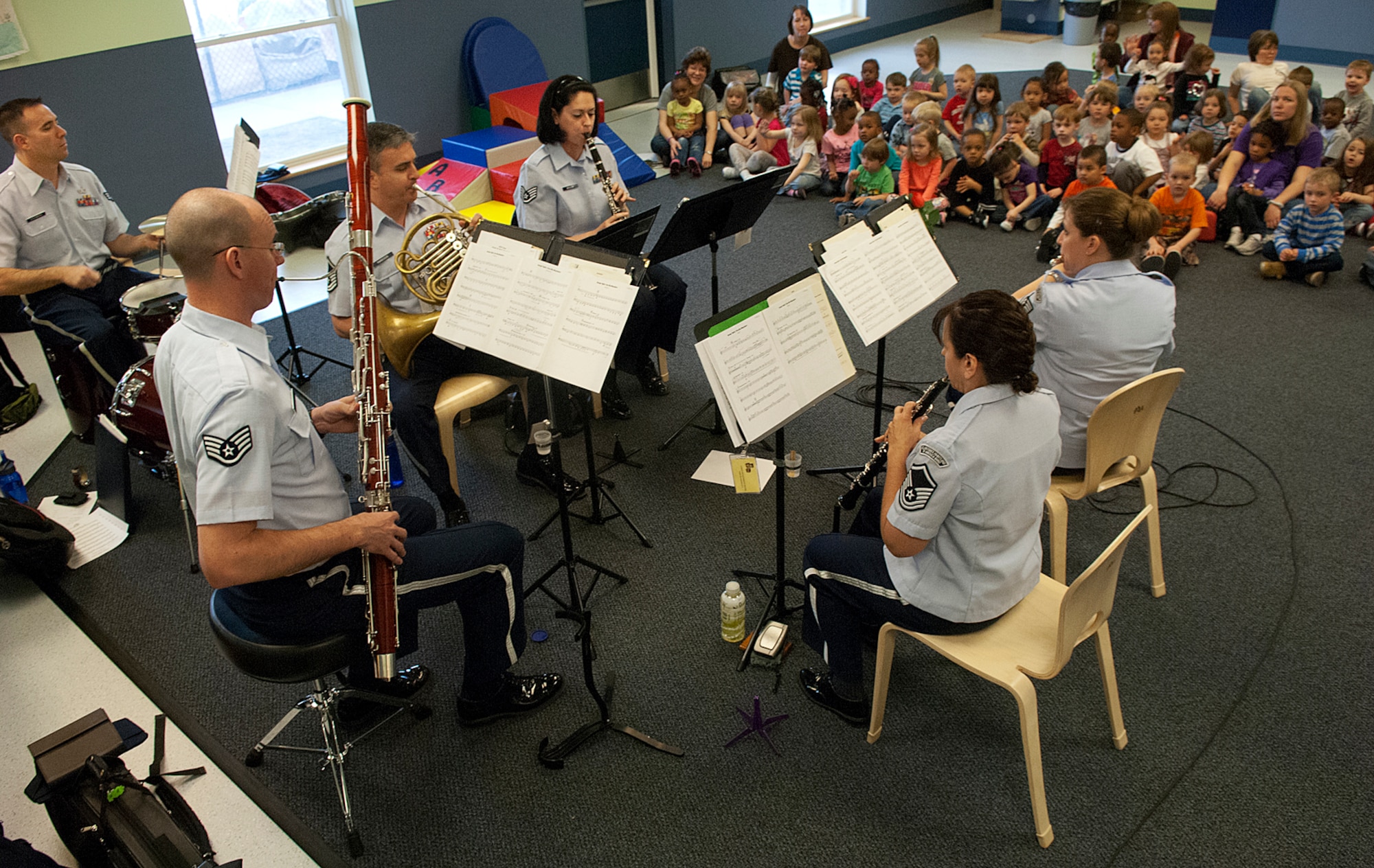 The Winds of Freedom, a wind ensemble with the U.S. Air Force Heartland of America Band out of Offutt Air Force Base, Neb., perform for children in the F. E. Warren Child Development Center March 28. The group was on a tour of Wyoming towns giving concerts as part of Music in our Schools Month. (U.S. Air Force photo by R.J. Oriez)