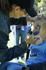 CHARLESTON, S.C. (April 7, 2012) - Shannon Boyd paints a shark on six-year old Logan Floding’s face during the Easter Egg Hunt and Month of the Military Child Festival at Marrington Plantation at Joint Base Charleston – Weapons Station, April 7. Hundreds of Air Force and Navy service members and their families, along with Department of Defense employees, retirees and Reserve members joined in the festivities which featured food to choose from, games, a bouncy castle, face painting and raffle prizes. Logan is the son of Petty Officer 1st Class Zach Floding assigned to the Navy Nuclear Power Unit at JB Charleston – Weapons Station. (U.S. Navy photo/Petty Officer 1st Class Jennifer Hudson)
