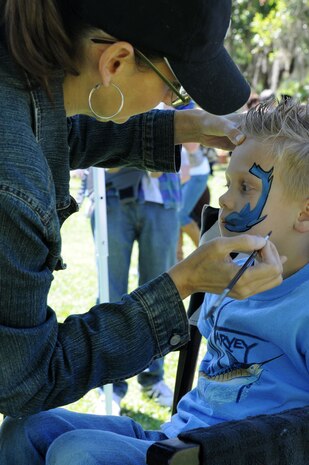 CHARLESTON, S.C. (April 7, 2012) - Shannon Boyd paints a shark on six-year old Logan Floding’s face during the Easter Egg Hunt and Month of the Military Child Festival at Marrington Plantation at Joint Base Charleston – Weapons Station, April 7. Hundreds of Air Force and Navy service members and their families, along with Department of Defense employees, retirees and Reserve members joined in the festivities which featured food to choose from, games, a bouncy castle, face painting and raffle prizes. Logan is the son of Petty Officer 1st Class Zach Floding assigned to the Navy Nuclear Power Unit at JB Charleston – Weapons Station. (U.S. Navy photo/Petty Officer 1st Class Jennifer Hudson)