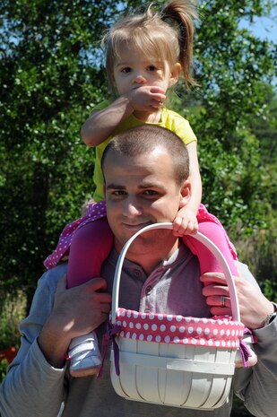 CHARLESTON, S.C. (April 7, 2012) Ensign Philip Nadenbousch gives his two-year-old daughter, Evelyn, a ride on his shoulders during the Easter Egg Hunt and Month of the Military Child Festival at Marrington Plantation at Joint Base Charleston – Weapons Station April 7. Hundreds of Air Force and Navy service members and their families, along with Department of Defense employees, retirees and Reserve members joined in the festivities which featured food to choose from, games, a bouncy castle, face painting and raffle prizes. Ens. Nadenbousch is assigned to the Naval Nuclear Power Training Command at JB Charleston – Weapons Station. (U.S. Navy photo/Petty Officer 1st Class Jennifer Hudson)