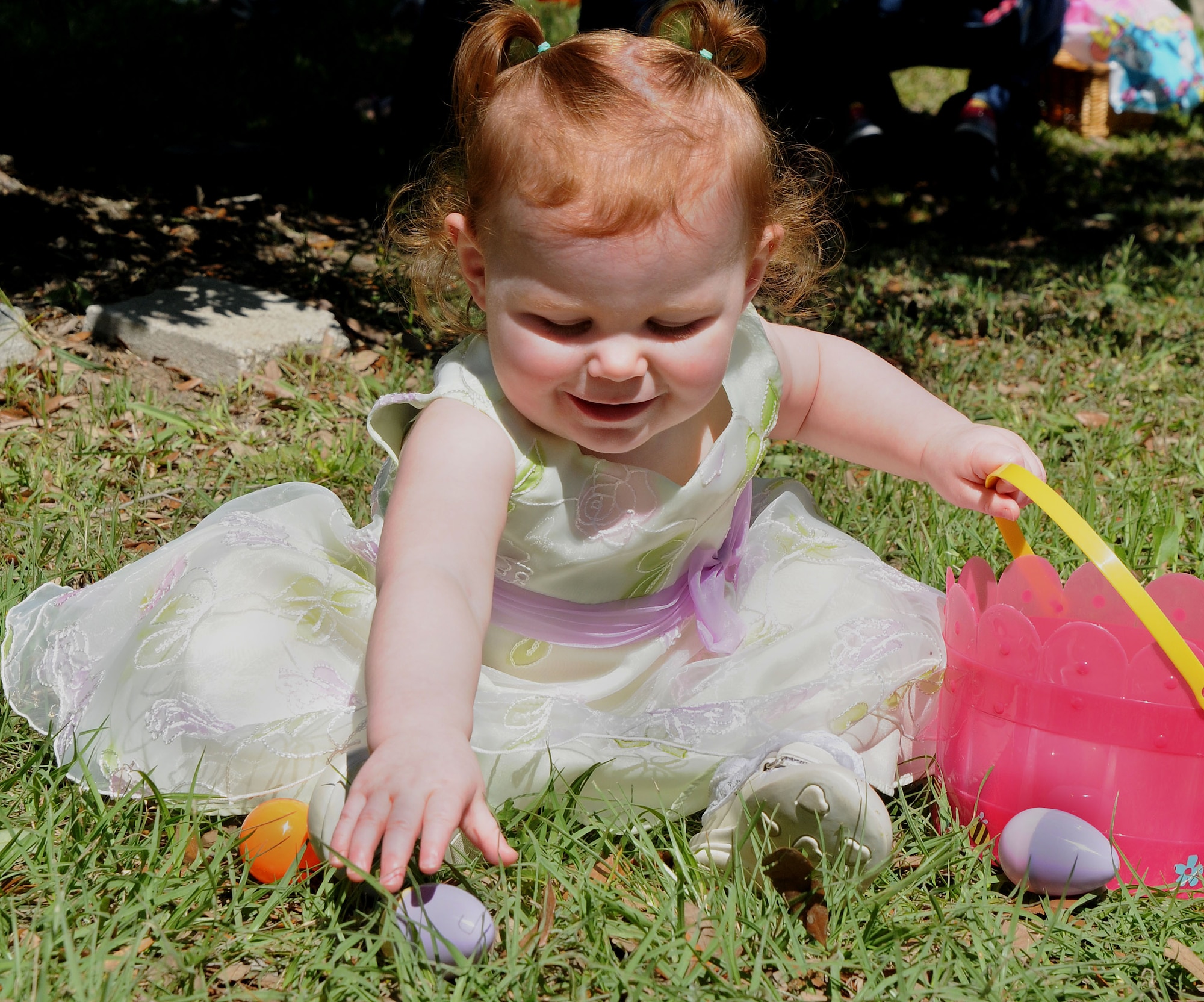 120407-N-IW469-018 CHARLESTON, S.C. (April 7, 2012) Staff Sgt. Bryan Weaber’s 18-month old daughter Rachael, plays with a plastic egg at the Easter Egg Hunt and Month of the Military Child Festival at Marrington Plantation at Joint Base Charleston – Weapons Station April 7. Hundreds of Air Force and Navy service members and their families, along with Department of Defense employees, retirees and Reserve members joined in the festivities which featured food to choose from, games, a bouncy castle, face painting and raffle prizes. Weaber is assigned to the 628th Communication Squadron at JB Charleston – Air Base.  (U.S. Navy photo/Petty Officer 1st Class Jennifer Hudson)