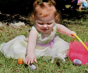 120407-N-IW469-018 CHARLESTON, S.C. (April 7, 2012) Staff Sgt. Bryan Weaber’s 18-month old daughter Rachael, plays with a plastic egg at the Easter Egg Hunt and Month of the Military Child Festival at Marrington Plantation at Joint Base Charleston – Weapons Station April 7. Hundreds of Air Force and Navy service members and their families, along with Department of Defense employees, retirees and Reserve members joined in the festivities which featured food to choose from, games, a bouncy castle, face painting and raffle prizes. Weaber is assigned to the 628th Communication Squadron at JB Charleston – Air Base.  (U.S. Navy photo/Petty Officer 1st Class Jennifer Hudson)