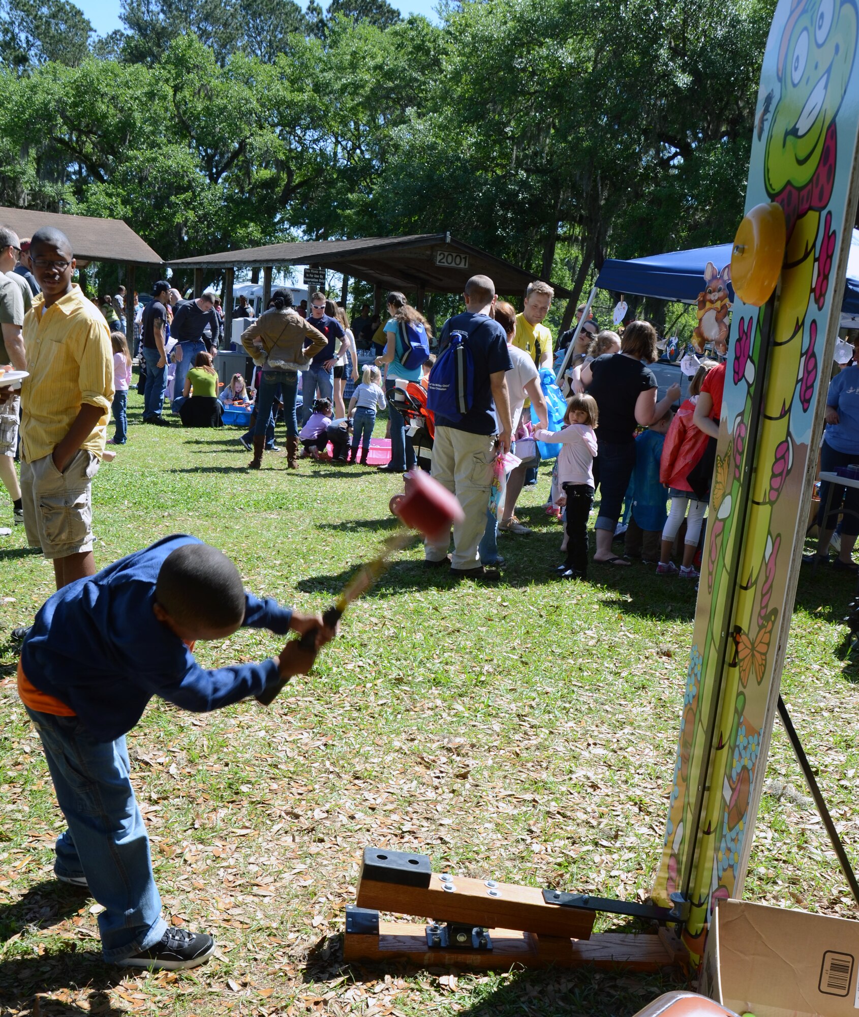 CHARLESTON, S.C. (April 7, 2012) - Five-year-old Thaison Jones tests his strength  during the Easter Egg Hunt and Month of the Military Child Festival held at Marrington Plantation at Joint Base Charleston-Weapons Station April 7. The event was open to service members, Department of Defense personnel and their families and provided games, food and fun for the whole family. Thaison is the son of Chief Master Sgt. Avery Jones. (U.S. Air Force Photo / Airman 1st Class Tom Brading)