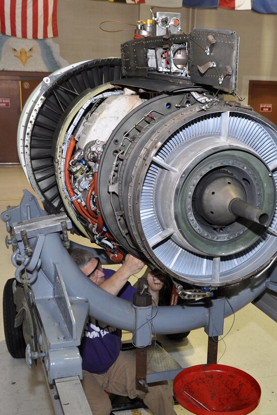 Guy Bretches, an Air Reserve Technician and A-10 jet mechanic assigned to the 917th Maintenance Squadron, pulls clamps off a TF34 jet engine in the 917th Propulsion Shop at Barksdale Air Force Base, La., March 30, 2012. Bretches is conducting an inspection of engine parts to look for damage that might have occurred during an alternative fuel certification process. (U.S. Air Force photo by Master Sgt. Jeff Walston) 