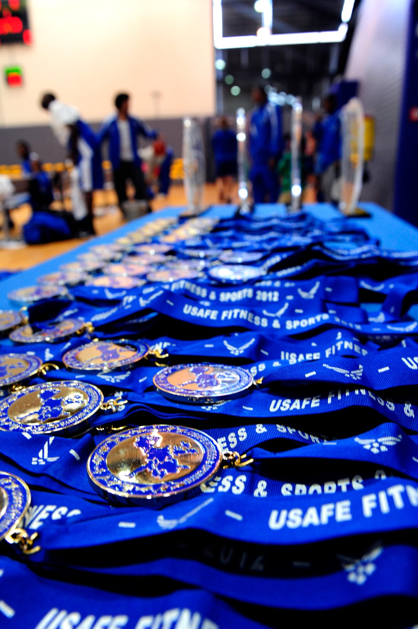 Medals and trophies sit on the sideline waiting to be handed out to the victors of the U.S. forces in Europe basketball tournament, Ramstein Air Base, Germany, April 8, 2012. (U.S. Air Force photo/ Senior Airman Aaron-Forrest Wainwright)