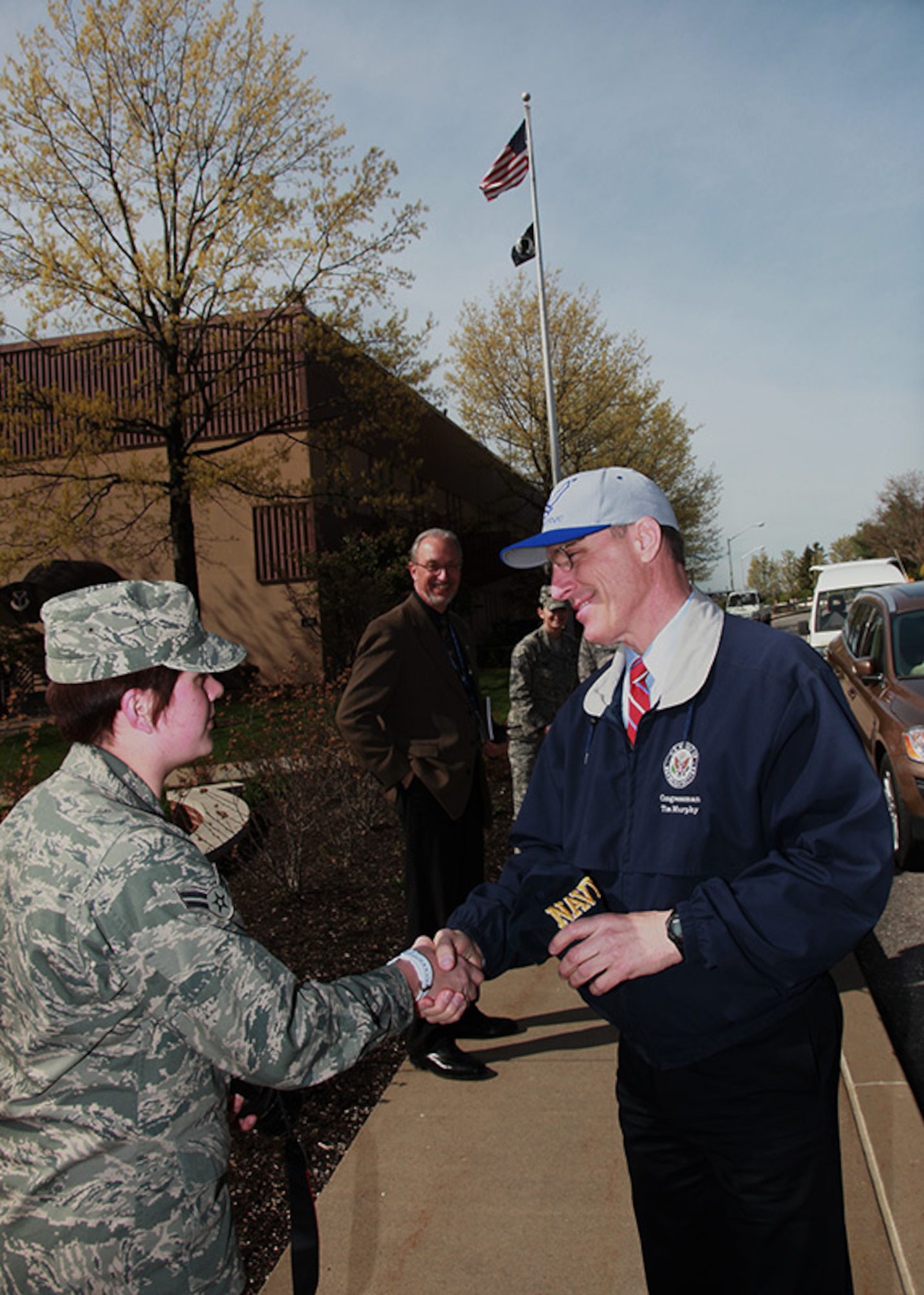 Airman 1st Class Justyne Obeldobel, a 911th Airlift Wing Public Affairs photographer, presents a U.S. Air Force Reserve cap from the base Recruiting Office to Rep. Tim Murphy, April 5, 2012. Rep. Murphy, R-PA 18, accompanied Rep. Bill Shuster, R-PA 9, in a brief tour of the 911th Airlift Wing, Apr. 5, 2012 (U.S. Air Force photo by Tech. Sgt. Ralph Van Houtem/Released)