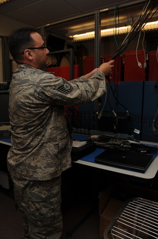 TSgt Salvador Alvarez prepares his workstation in the communications maintenance shop.