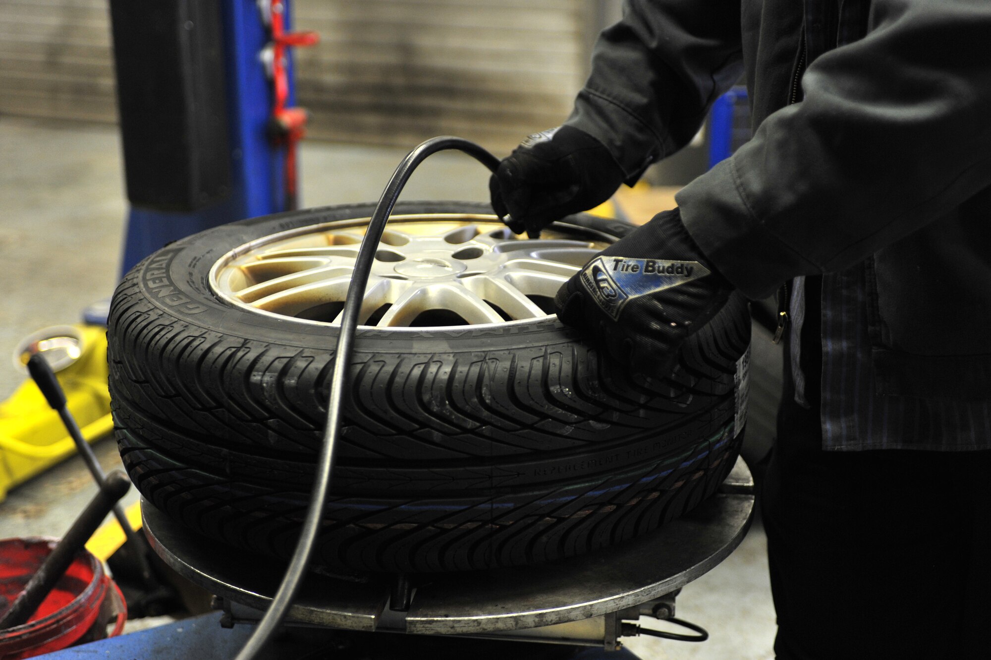 Steven Subocz, 86th Force Support Squadron Automotive Worker, adds air to a newly refurbished tire on Ramstein Air Base, April 9, 2012. The Auto Hobby Center is one of two auto shops on base that was reorganized to provide better customer service for military members and their families. (U.S. Air Force photo/Airman 1st Class Caitlin O'Neil-McKeown)