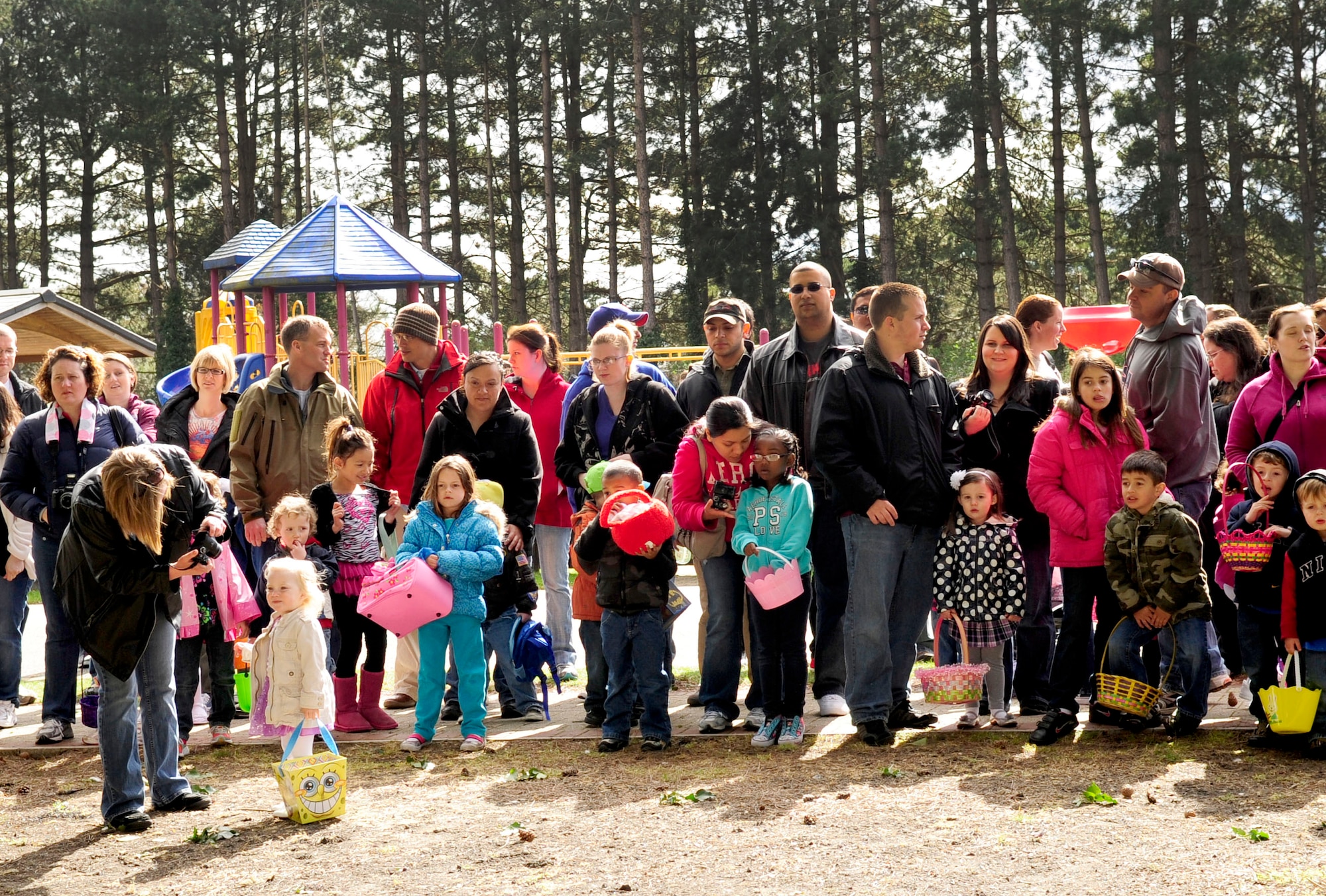 RAF MILDENHALL, England – Team Mildenhall members and their children wait for the Easter egg hunt to start during the “Easter Egg-citement” event held at Heritage Park here April 7, 2012. During the event there were four age-oriented egg hunts; each hunt had one silver and one golden egg. The kids who found the silver and golden eggs won an Easter basket. (U.S. Air Force photo/Senior Airman Ethan Morgan)