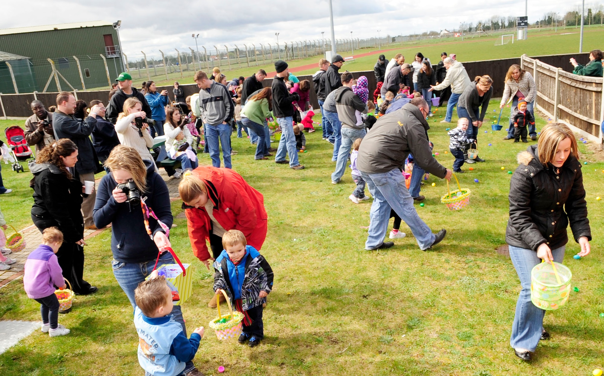 RAF MILDENHALL, England – Team Mildenhall members and their children pick up Easter eggs during the “Easter Egg-citement” event at Heritage Park April 7, 2012. There were four age specific egg hunts during the event that allowed all the children a chance to gather eggs. (U.S. Air Force photo/Senior Airman Ethan Morgan)
