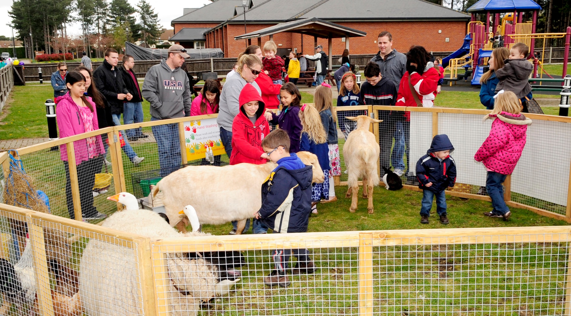 RAF MILDENHALL, England – Team Mildenhall members and their children pet animals at a mobile petting zoo during the “Easter Egg-citement” event at Heritage Park April 7, 2012. The event offered multiple family activities including games, Easter egg hunts and meeting the Easter bunny. (U.S. Air Force photo/Senior Airman Ethan Morgan)