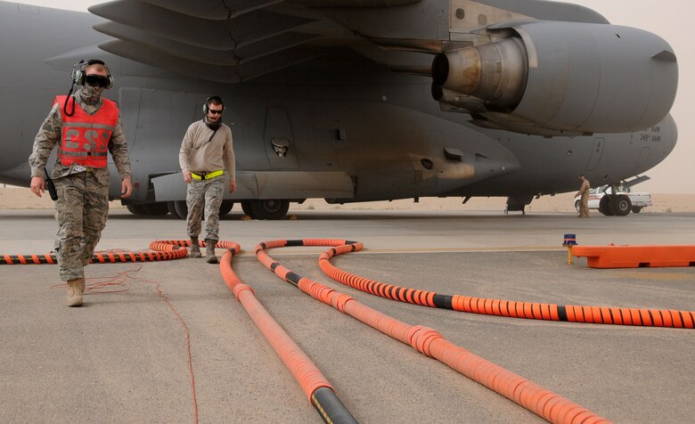 U.S. Air Force Senior Airmen Ryan Brown and Jordan Lavallee, members of the 5th Expeditionary Air Mobility Squadron, finish refueling operations on a C-17 globemaster at an undisclosed location in Southwest Asia, March 15, 2012. The 5th EAMS perform maintenance on C-17 Globemasters transiting in and out of U.S. Central Command?s area of responsibility. (U.S. Air Force photo by Staff Sgt. James Lieth/Released)