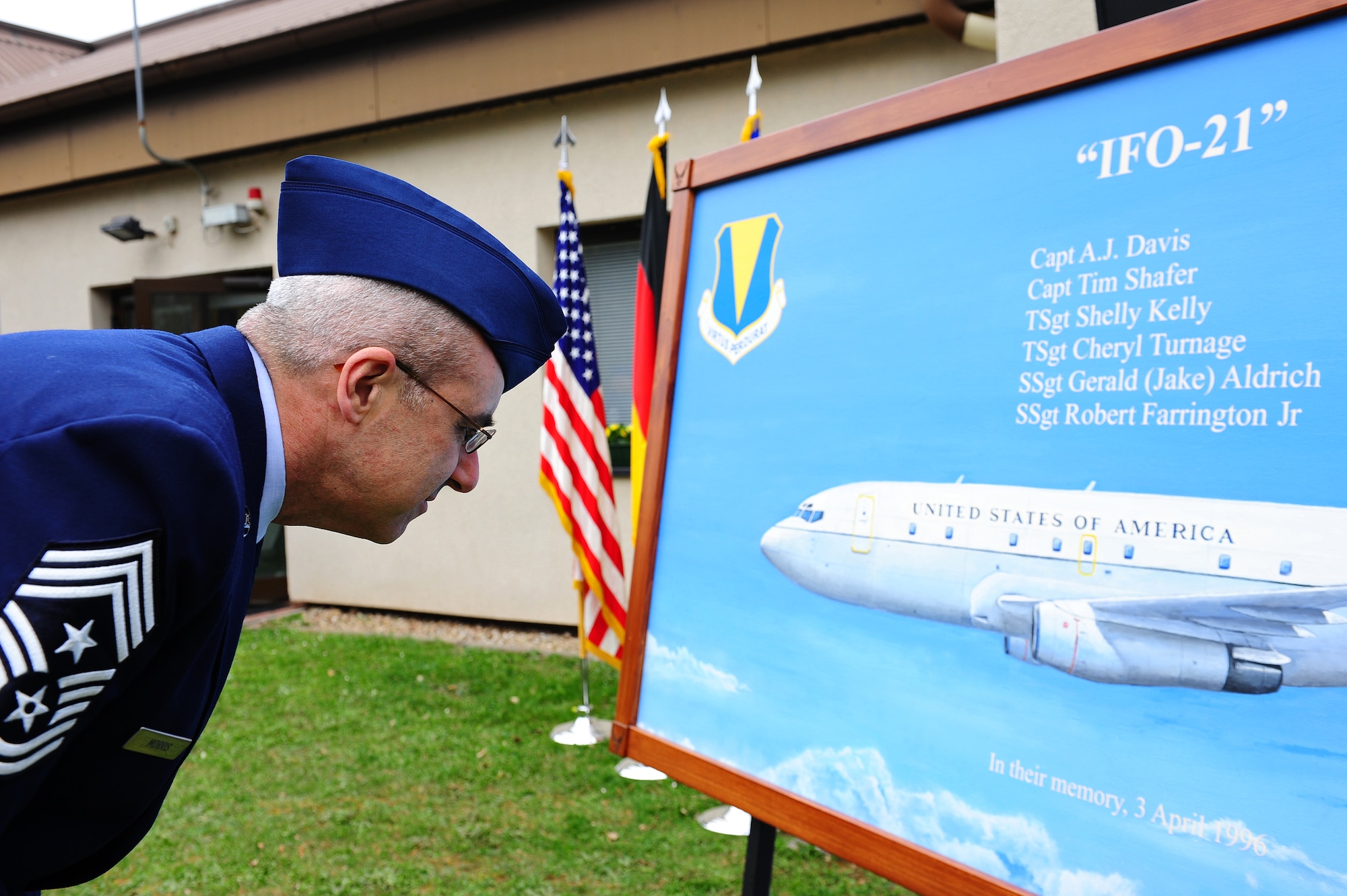 Chief Master Sgt. James Morris, 86th Airlift Wing command chief, takes a closer look at a painting during a memorial ceremony on Ramstein Air Base, April 5, 2012. The portrait was provided by Senior Master Sgt. Mel Sylvester (ret.) and Master Sgt. Mike Bulko (ret.) in honor of the members on flight IFO-21. On April 3, 1996, a CT-43 aircraft that was assigned to the 76th Airlift Squadron crashed outside of Dubrovnik Croatia during a peacekeeping mission. This year marked the 16th anniversary. (U.S. Air Force photo by Amn Brea Miller)