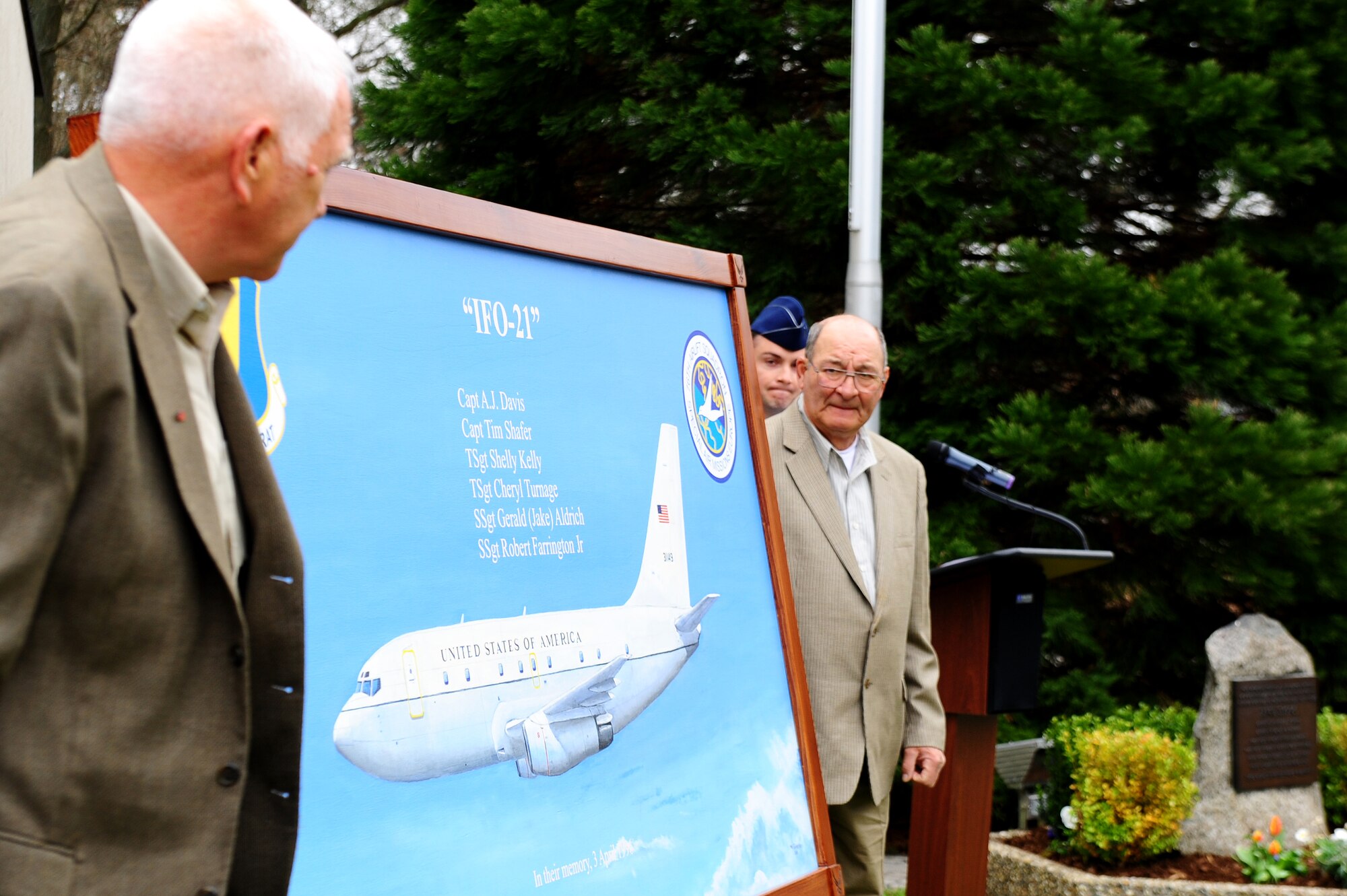 Senior Master Sgt. Mel Sylvester (ret.) and Master Sgt. Mike Bulko (ret.) present a painting during a memorial ceremony on Ramstein Air Base, April 5, 2012. Sylvester and Bulko painted the portrait in honor of the members on flight IFO-21. On April 3, 1996, a CT-43 aircraft that was assigned to the 76th Airlift Squadron crashed outside of Dubrovnik Croatia during a peacekeeping mission. The squadron honored the six crew members of flight IFO-21 this year marking the 16th anniversary. (U.S. Air Force photo by Amn Brea Miller)