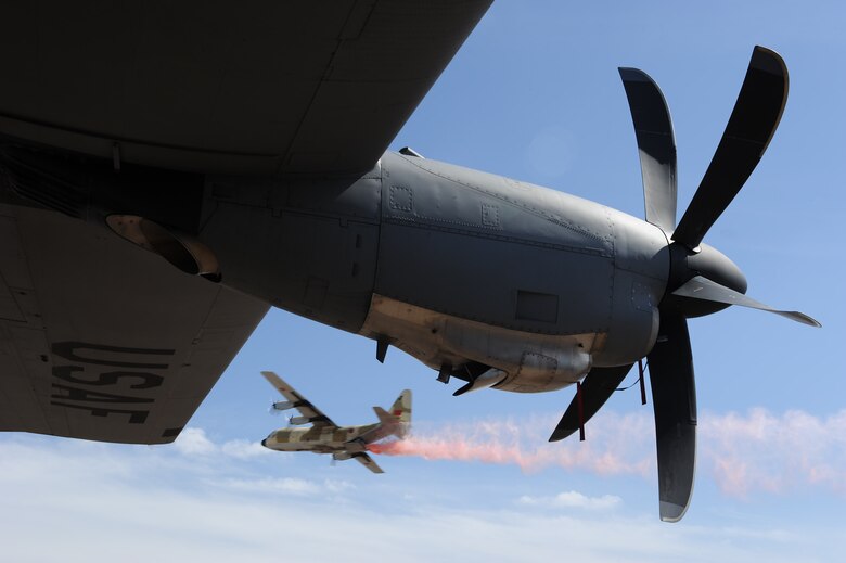 MARRAKECH, Morocco -- A Moroccan C-130 dumps fire retardant near a U.S. Air Force C-130J Super Hercules at Aeroexpo Marrakech 2012 April 7, 2012. U.S. Air Forces Africa participated in the third biennial Aeroexpo Marrakech to strengthen the partnerships with the nations involved and show commitment to security and stability in the region. (U.S. Air Force photo/Staff Sgt. Benjamin Wilson)