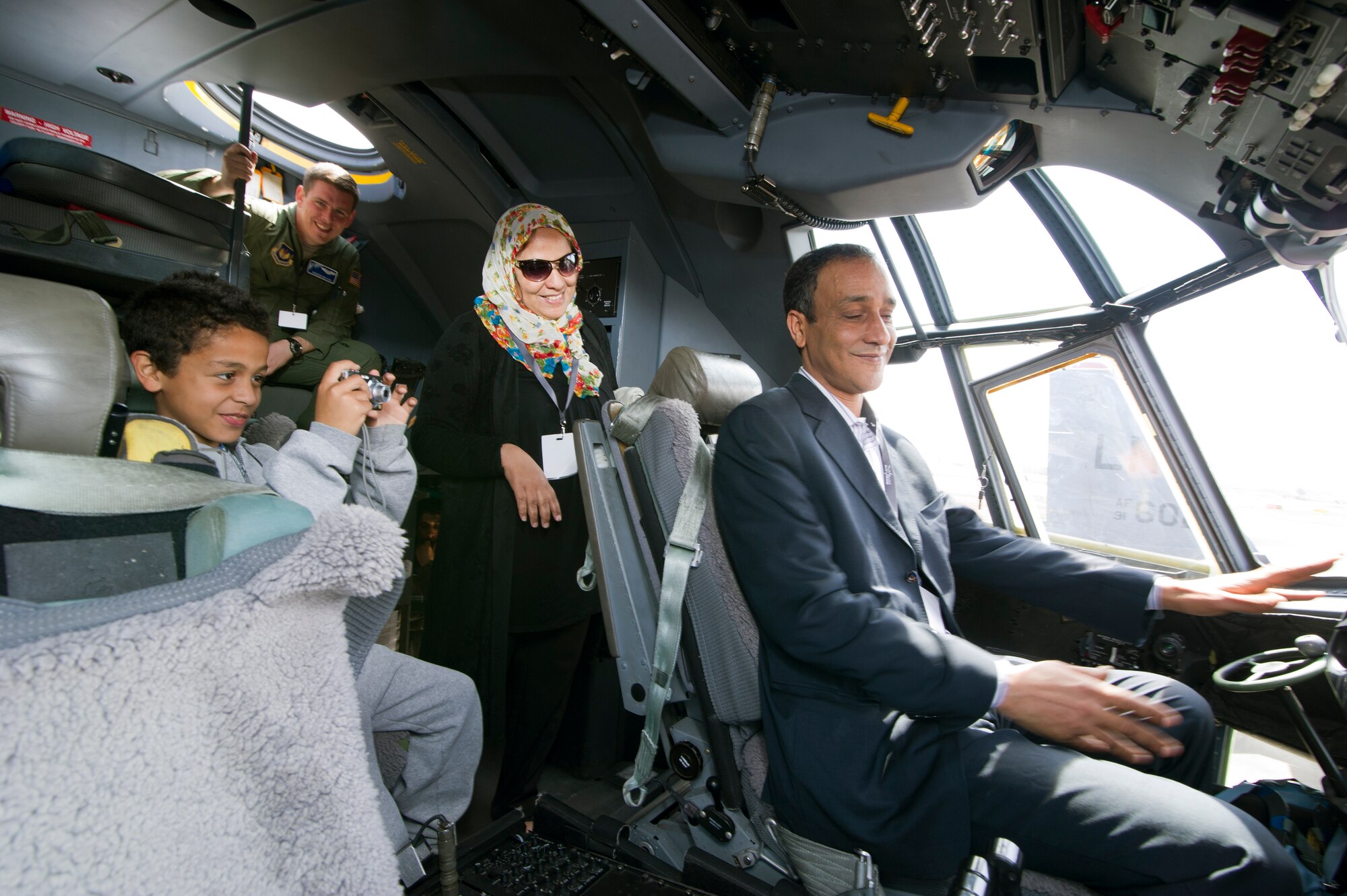 MARRAKECH, Morocco -- A Moroccan family takes photos in the flight deck of a C-130J Super Hercules at Aeroexpo Marrakech 2012 April 7, 2012. U.S. Air Forces Africa participated in the third biennial Aeroexpo Marrakech to strengthen the partnerships with the nations involved and show commitment to security and stability in the region. (U.S. Air Force photo/Staff Sgt. Benjamin Wilson)