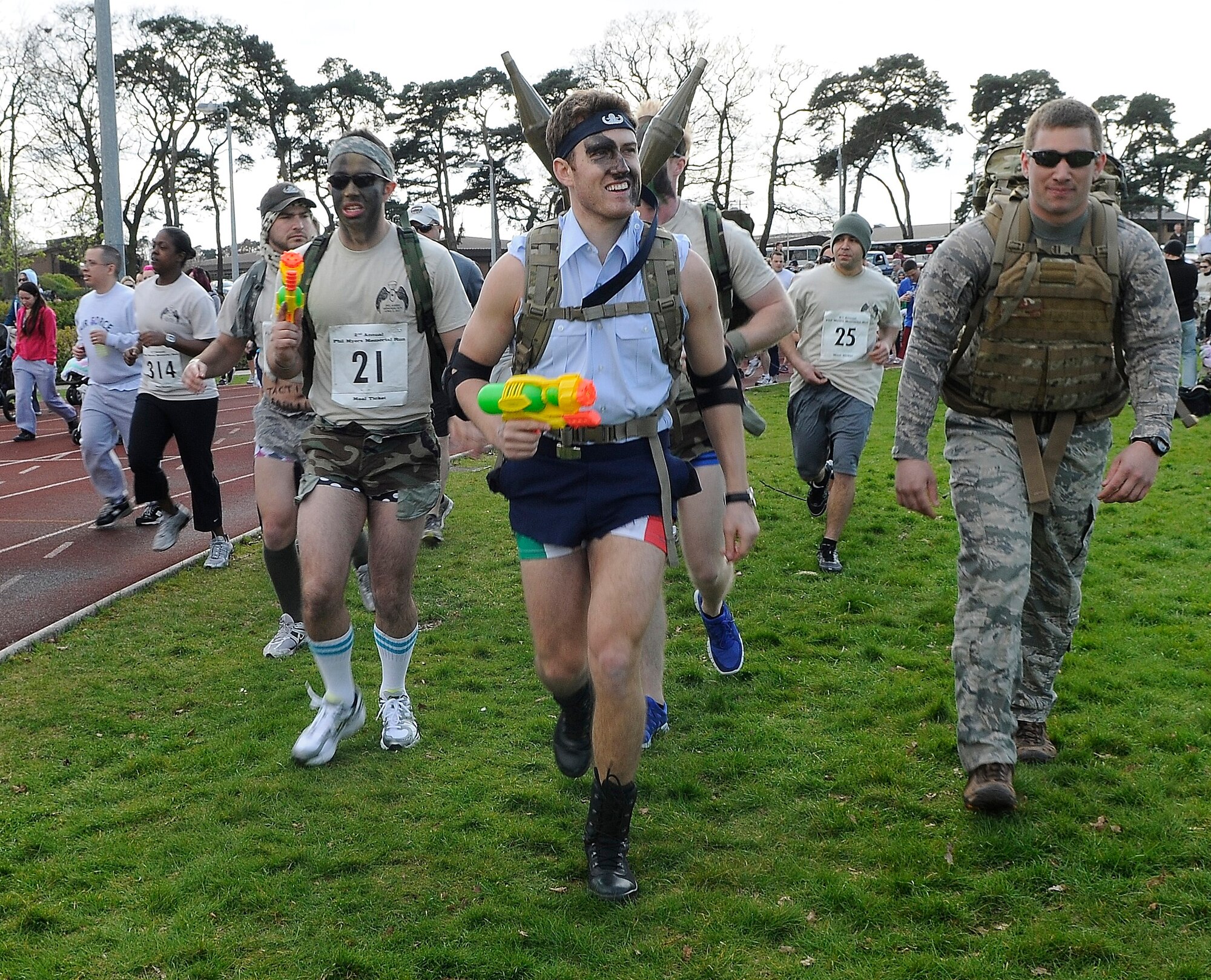 ROYAL AIR FORCE LAKENHEATH, England -- Members of the 48th Civil Engineer Squadron explosive ordnance disposal flight came out in costume to run in the second annual Phil Myers Memorial Run at the RAF Lakenheath running track April 5, 2012. Myers was a member of the 48th Civil Engineer Squadron explosive ordnance disposal flight who died as a result of an improvised explosive device attack while deployed to Afghanistan in 2009.  The 5K run/walk began at the track and ended at the Phil Myers Memorial on Myers Way.  All donations from the event will go to the EOD Memorial Foundation and the Wounded Warrior Project.  (U.S. Air Force photo by Staff Sgt. Connor Estes)