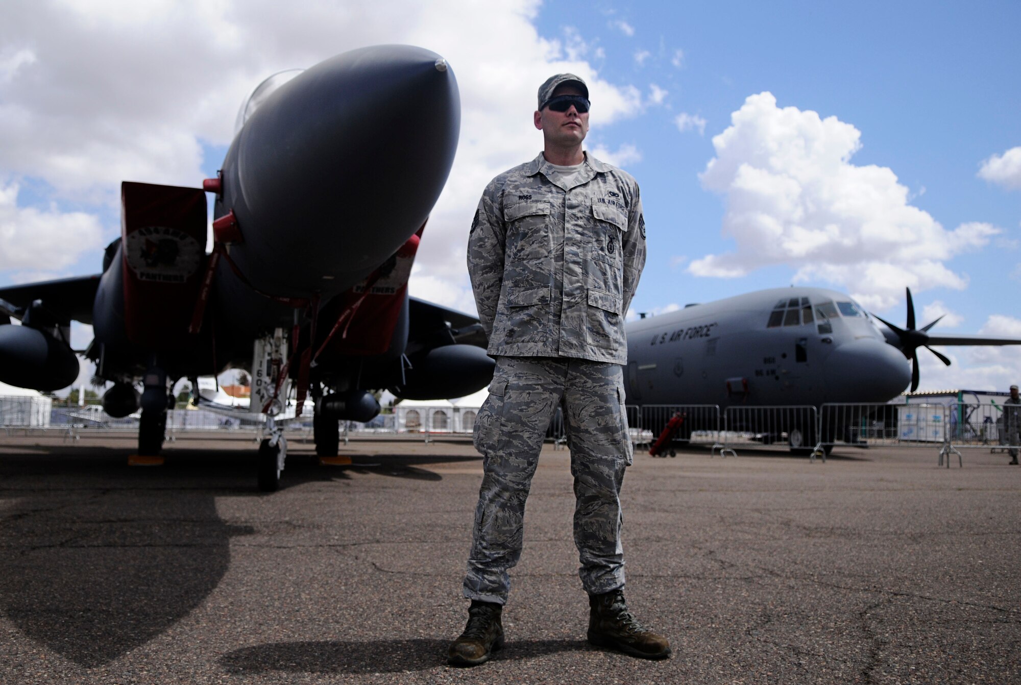 MARRAKECH, Morrocco— Staff Sgt. Matthew Ross, 818th Contingency Response Group security forces fire team leader, stands guard between a U.S. Air Force F-15E Strike Eagle and a C-130J Super Hercules April 5, 2012 during the Aeroexpo Marrakech 2012. The U.S. Air Force is participating in the third biennial Aeroexpo Marrakech to strengthen the partnerships with the nations involved and show commitment to security and stability in the region. Security forces teams members are providing security for U.S. aircraft for the entirety of the Aeroexpo. (U.S. Air Force photo/Senior Airman Natasha Stannard)