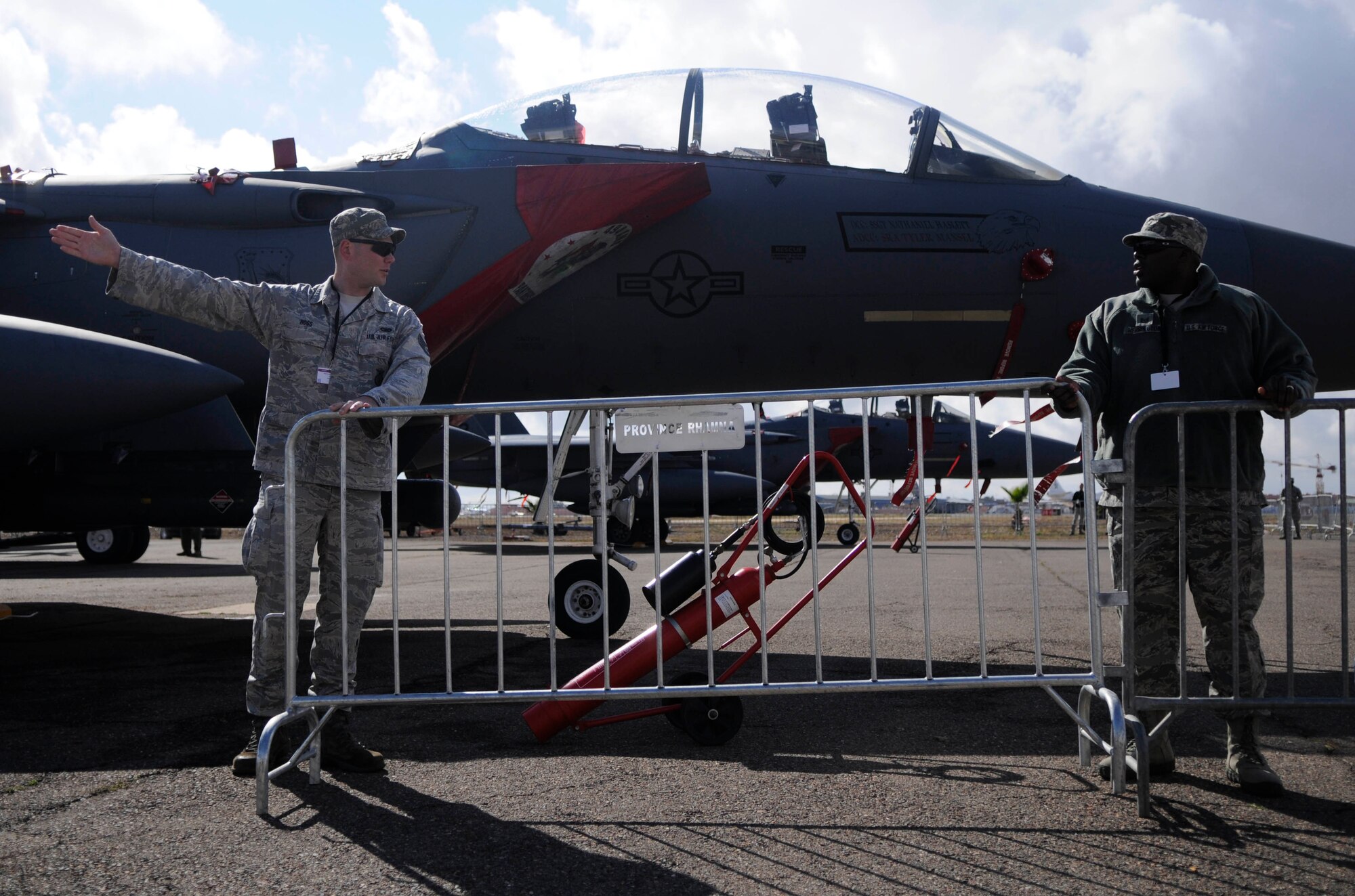MARRAKECH, Morocco -- Tech. Sgt. Bruce Herrington, left, and Staff Sgt. Matthew Ross move barriers move security barriers around U.S. aircraft April 5, 2012 at the 2012 Marrakech Aeroexpo. Herrington and Ross are members of the 818th Contingency Response Group and are at the Aeroexpo to provide security for U.S. aircraft at the event. They also act as liaisons for visitors with questions about the aircraft. The U.S. Air Force is participating in the third biennial Aeroexpo Marrakech to strengthen the partnerships with the nations involved and show commitment to security and stability in the region. Security forces team members are providing security for U.S. aircraft for the entirety of the Aeroexpo. (U.S. Air Force photo by Senior Airman Natasha Stannard)